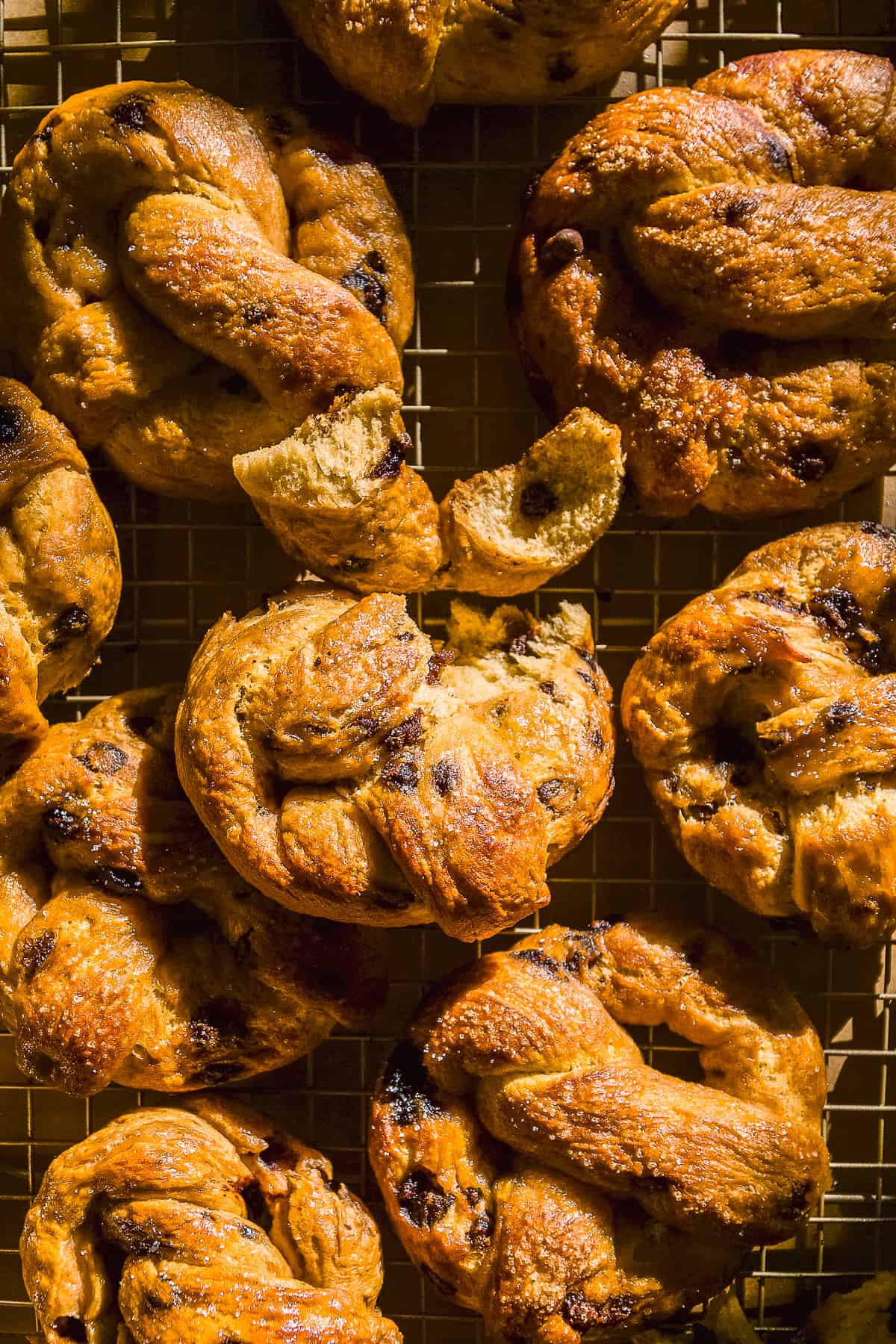 Pumpkin chocolate chip pretzels scattered on a wire rack.