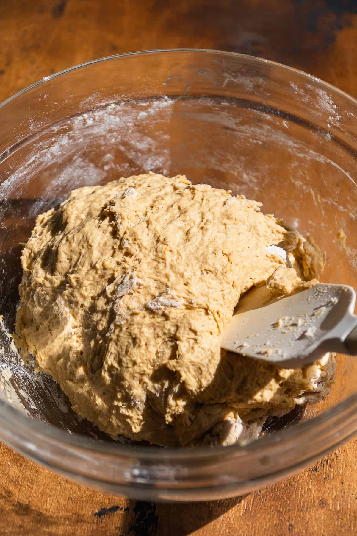 Pumpkin pretzel dough in a glass bowl.