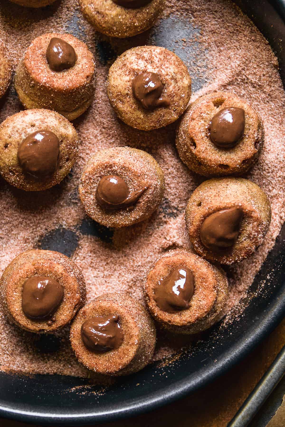 Churro donut holes with chocolate SunButter in the middle.