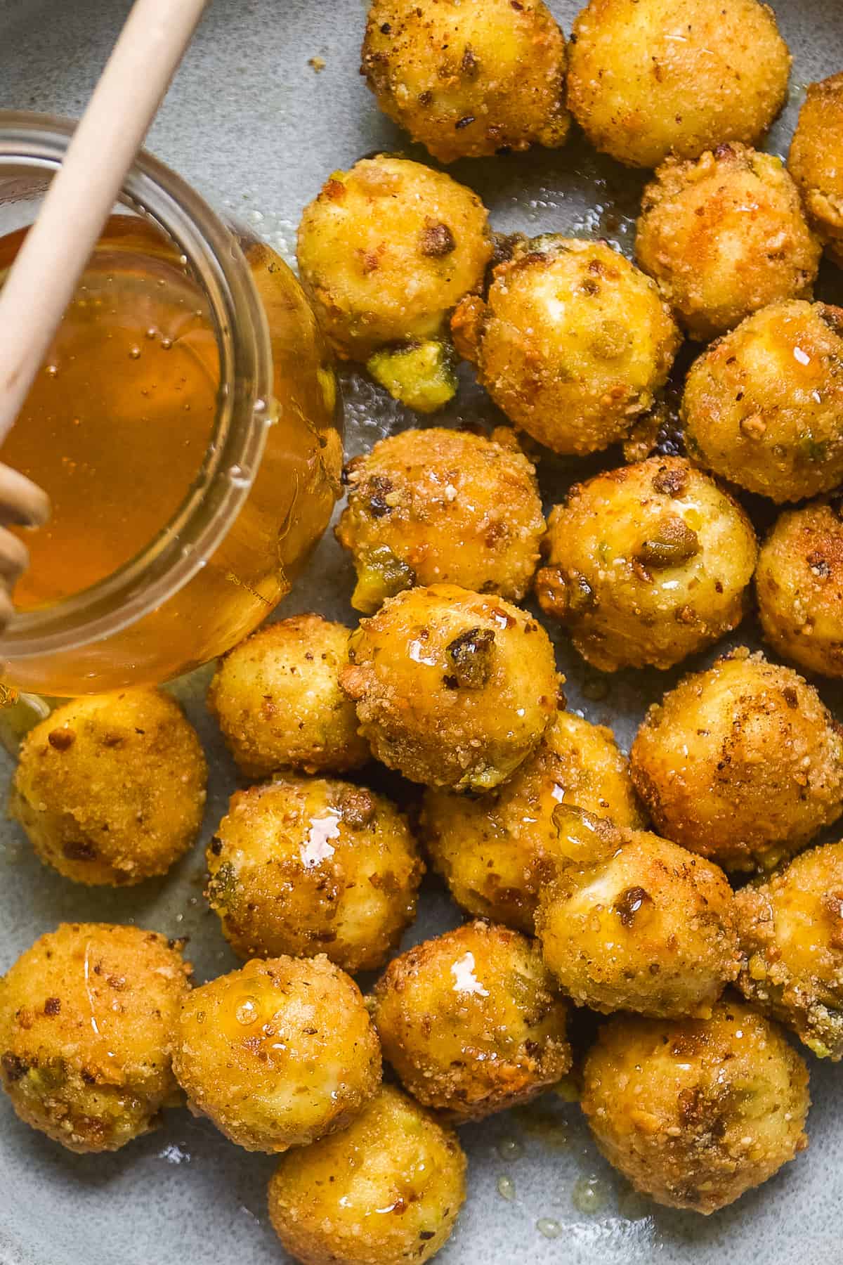 Up close view of fried goat cheese balls on a blue plate