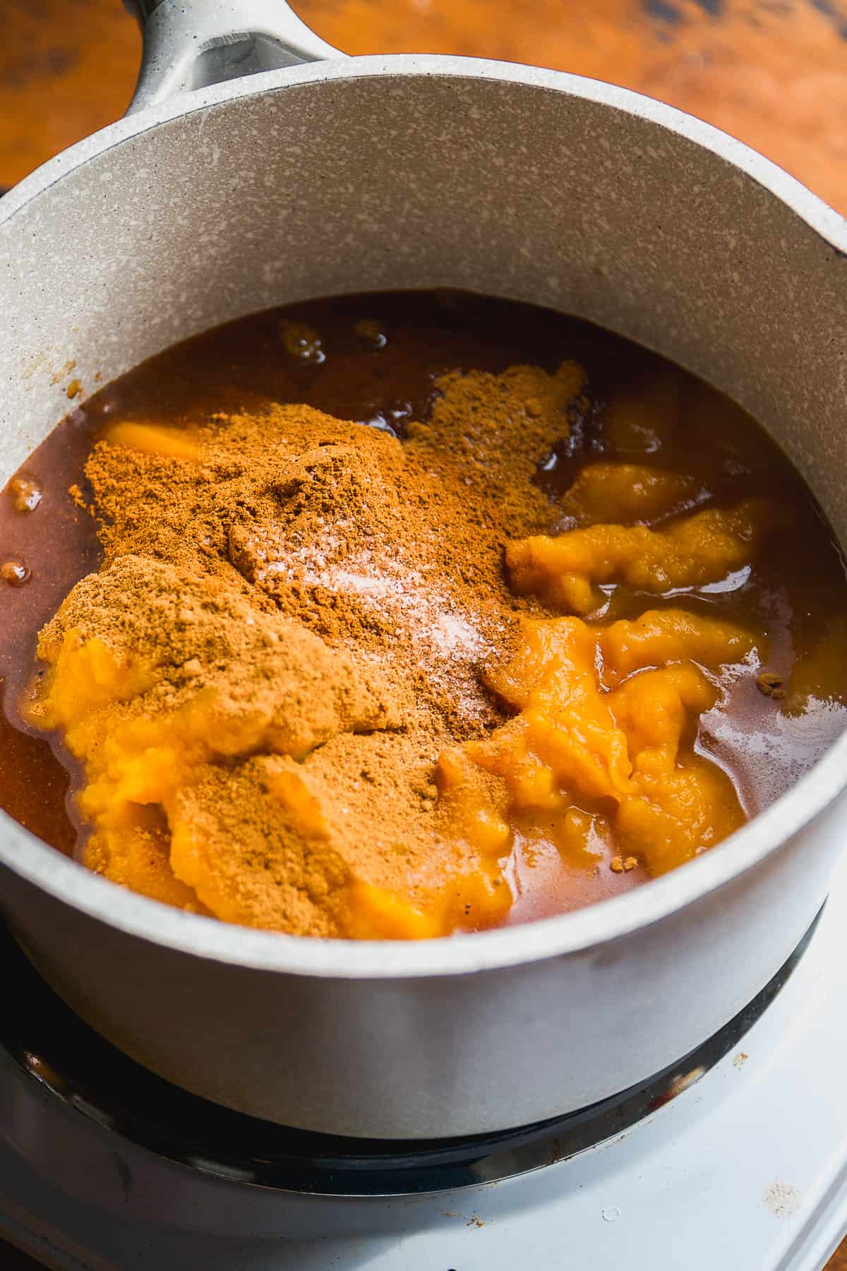 Pumpkin butter ingredients in a gray pot.