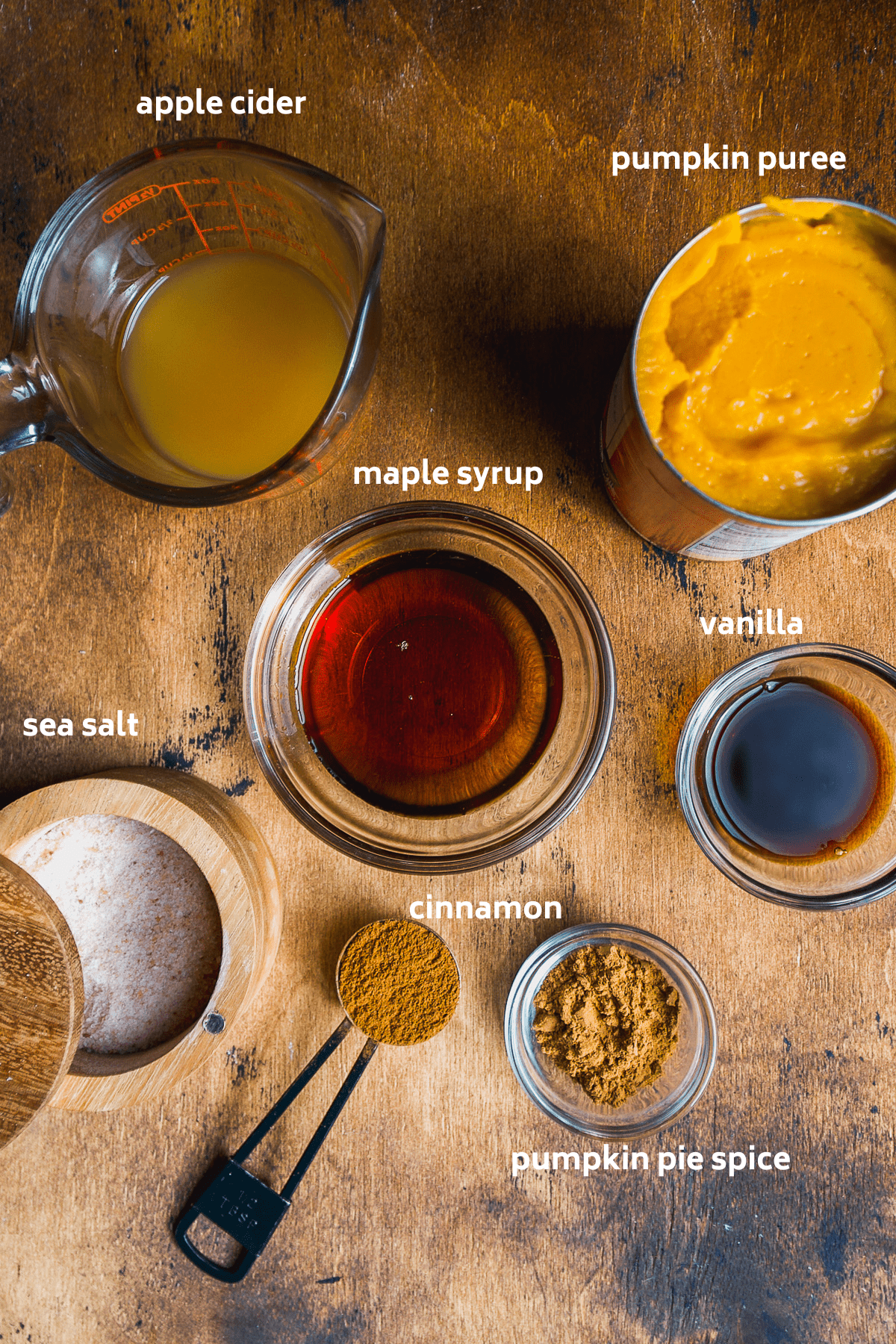 Pumpkin butter ingredients on a wooden surface.