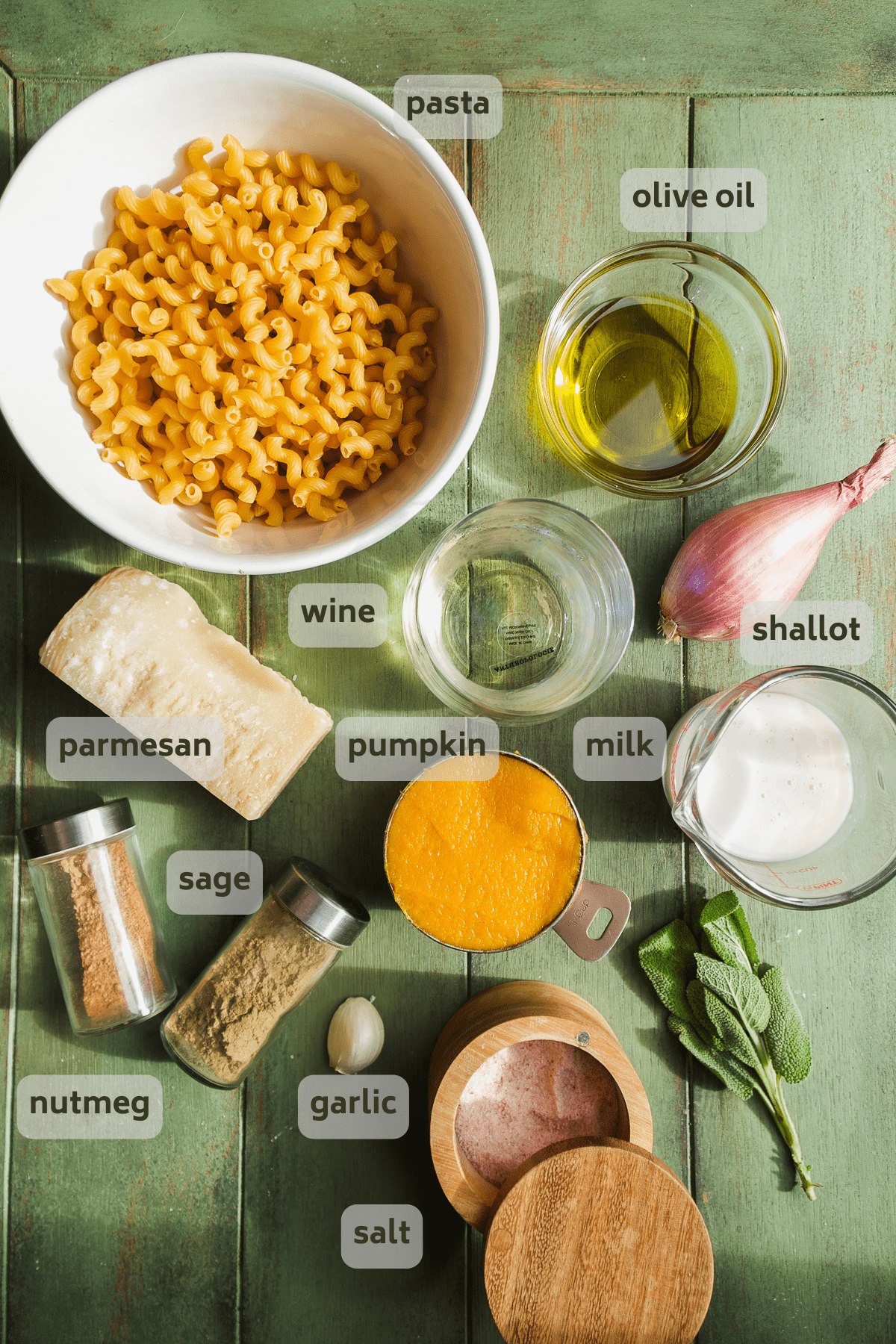 Pumpkin pasta ingredients on a green surface.