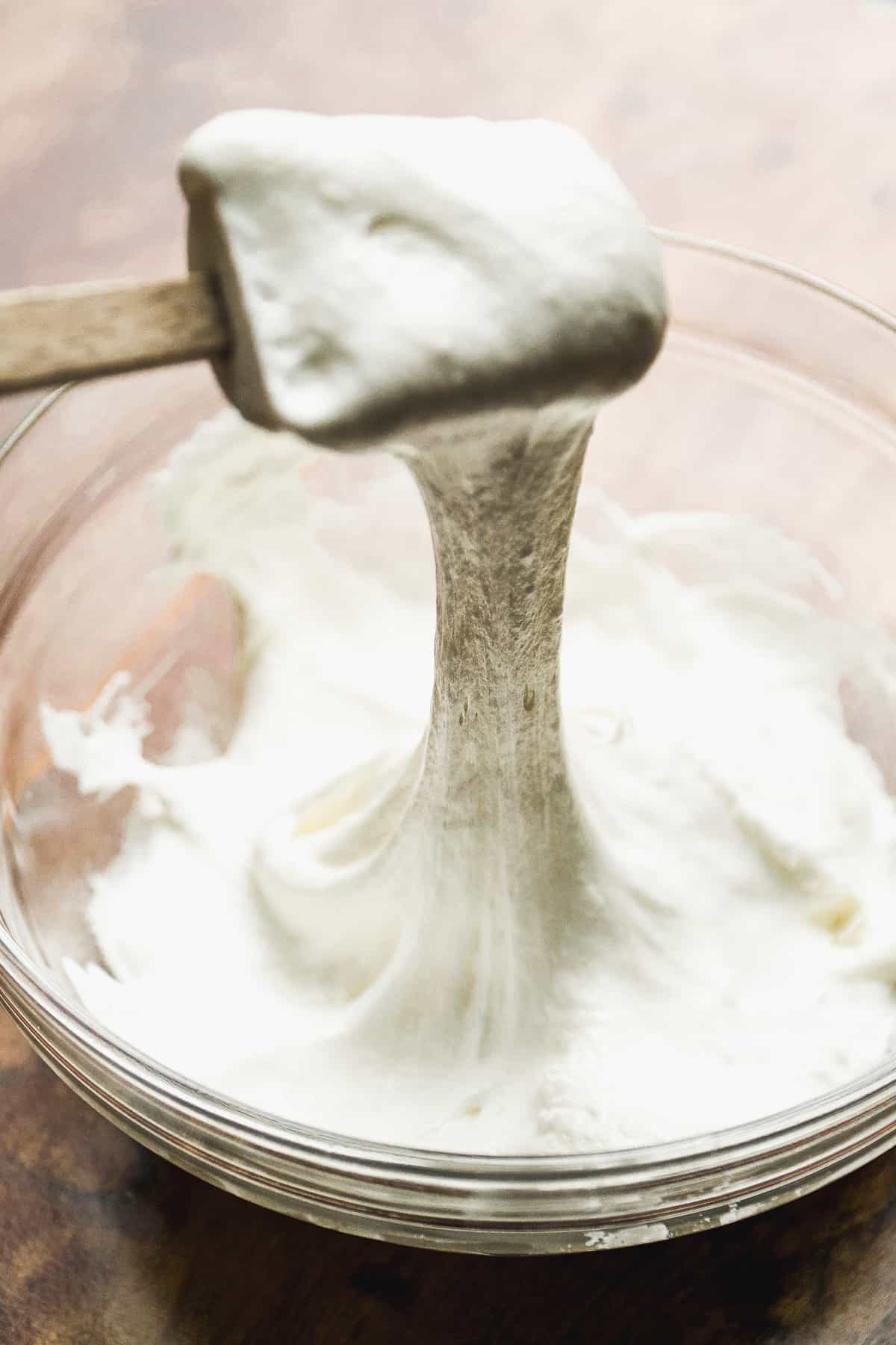 Melted marshmallow in a glass bowl.