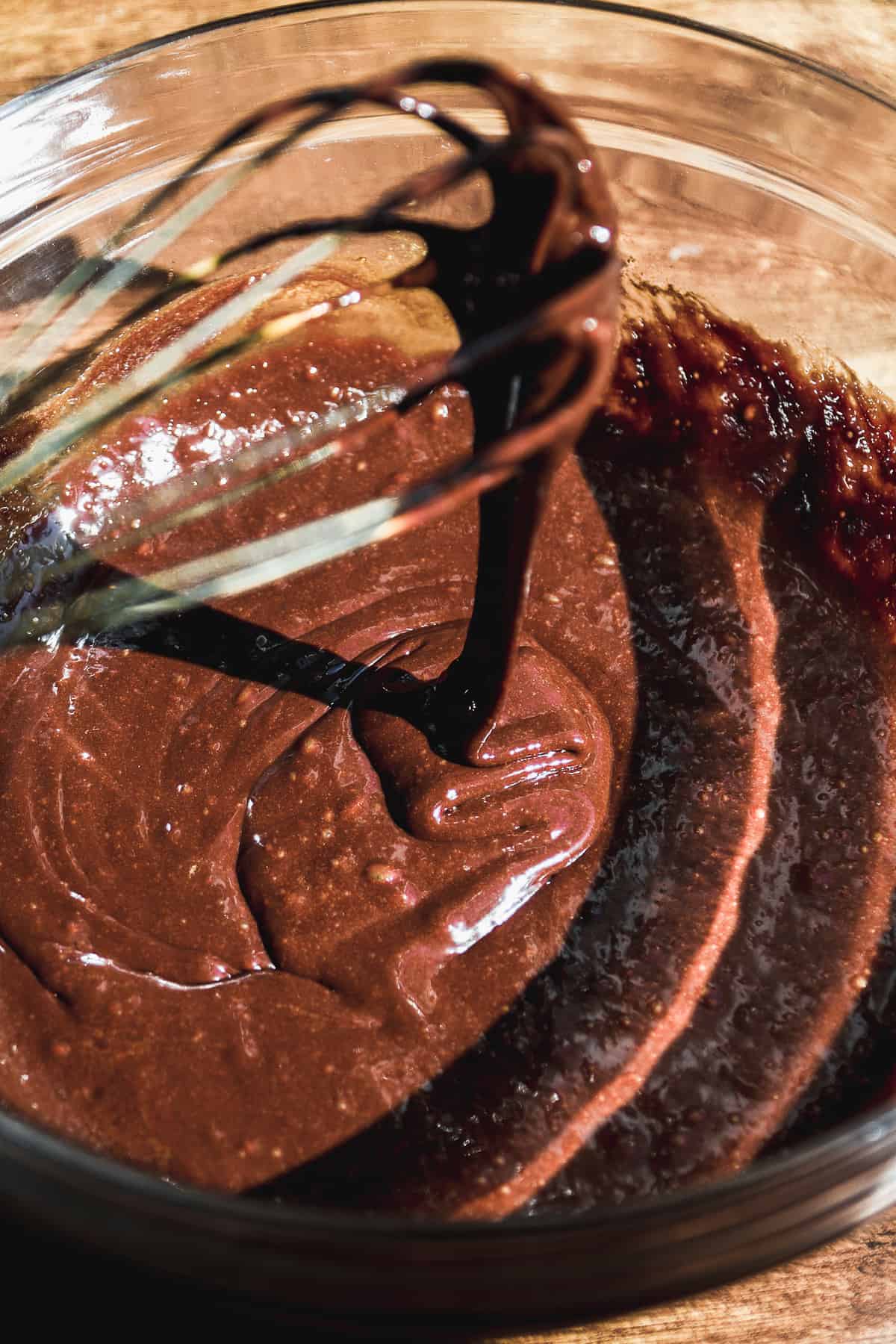 Chocolate cookie batter in a glass bowl.