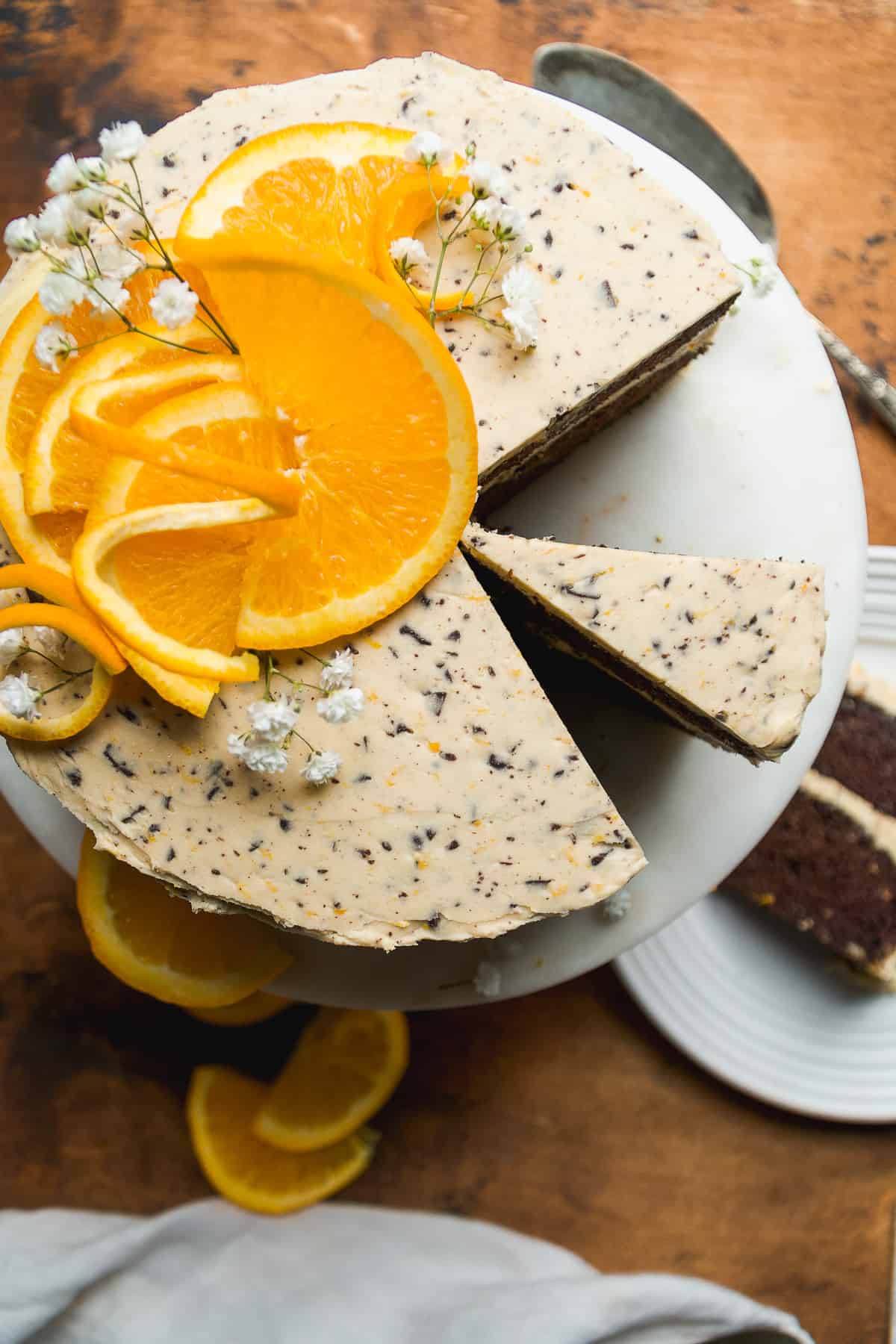 Overhead view of a chocolate orange cake with a slice cut out.