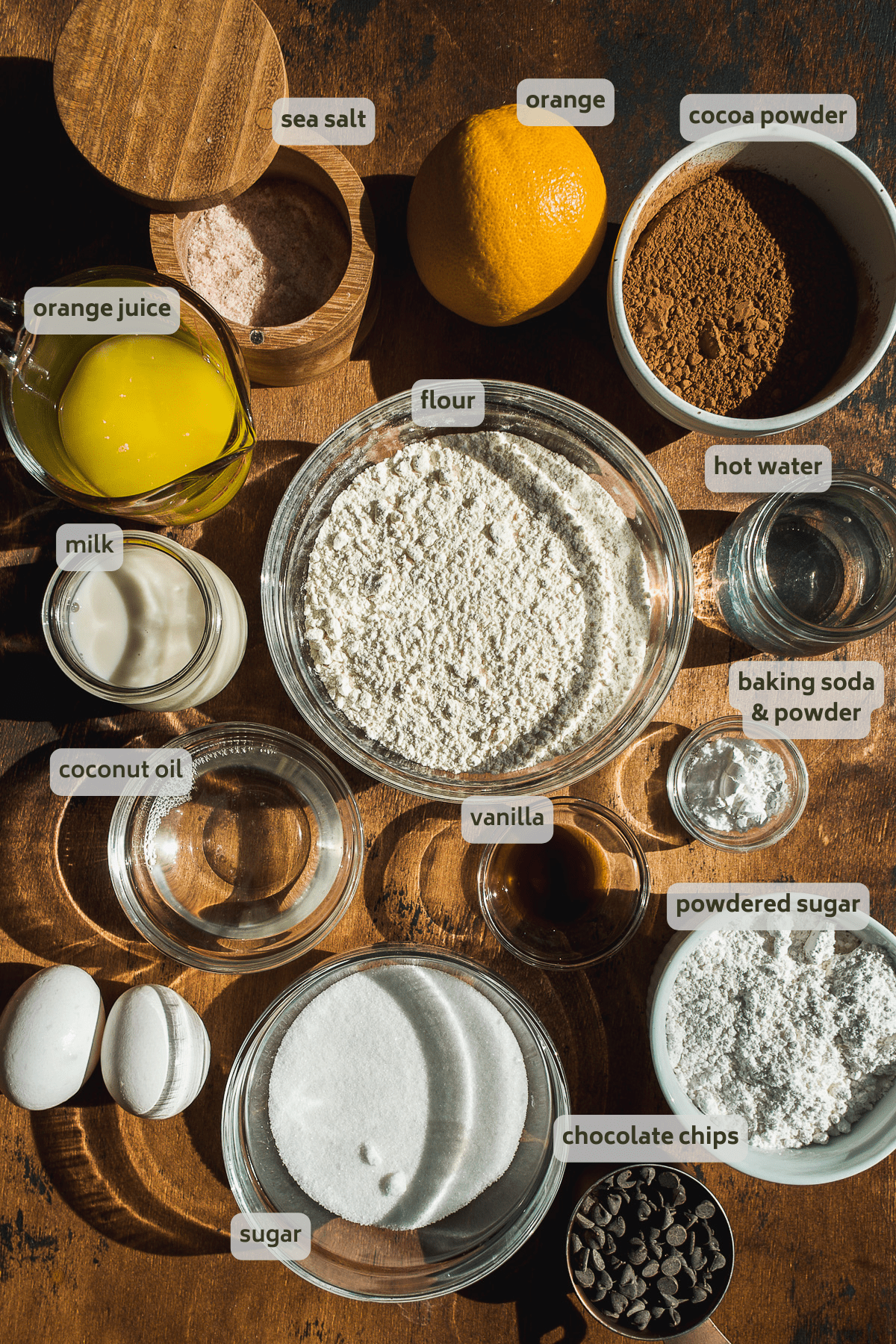 Chocolate orange cake ingredients on a wooden surface.