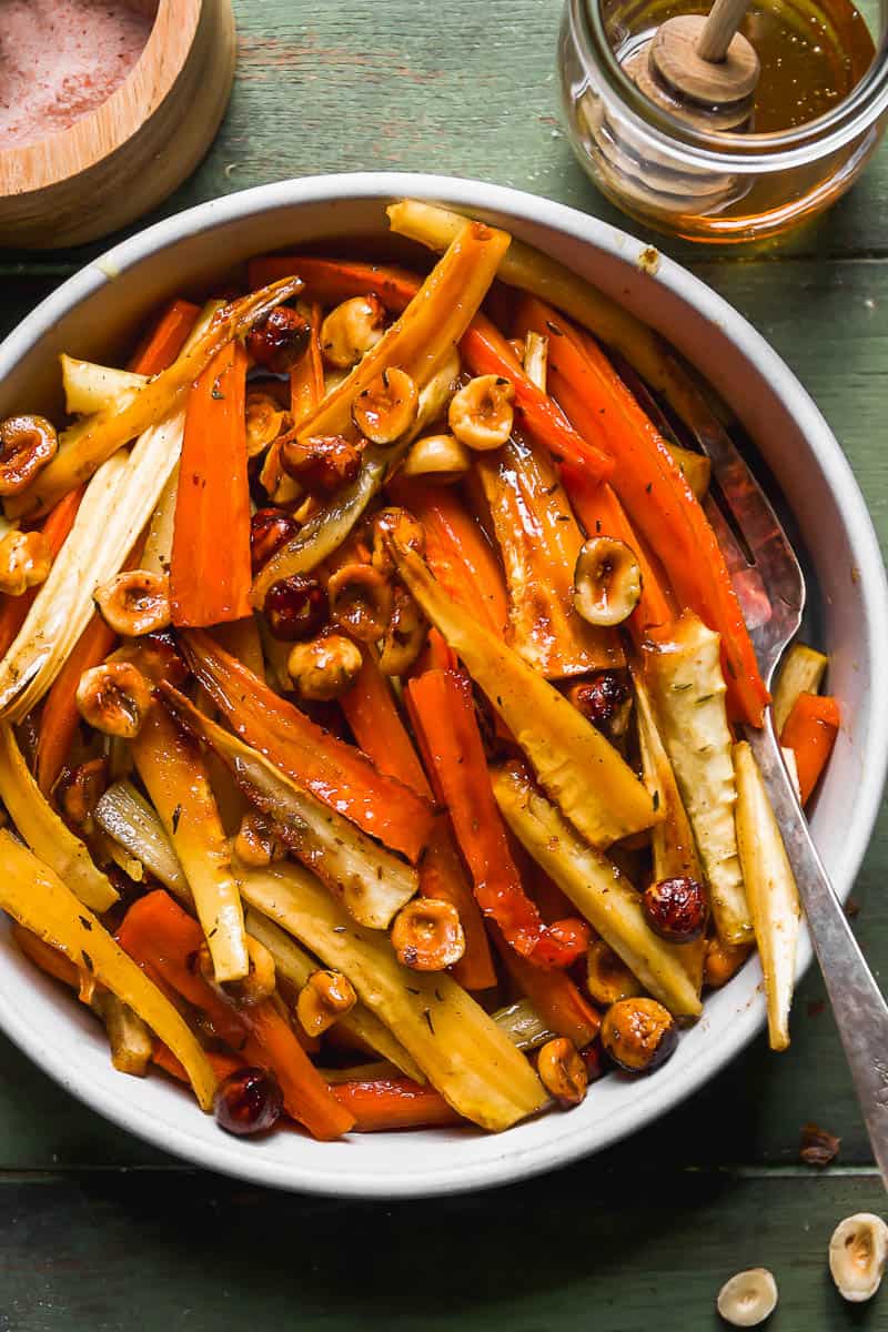 Carrots and parsnips roasted in honey in a serving dish.