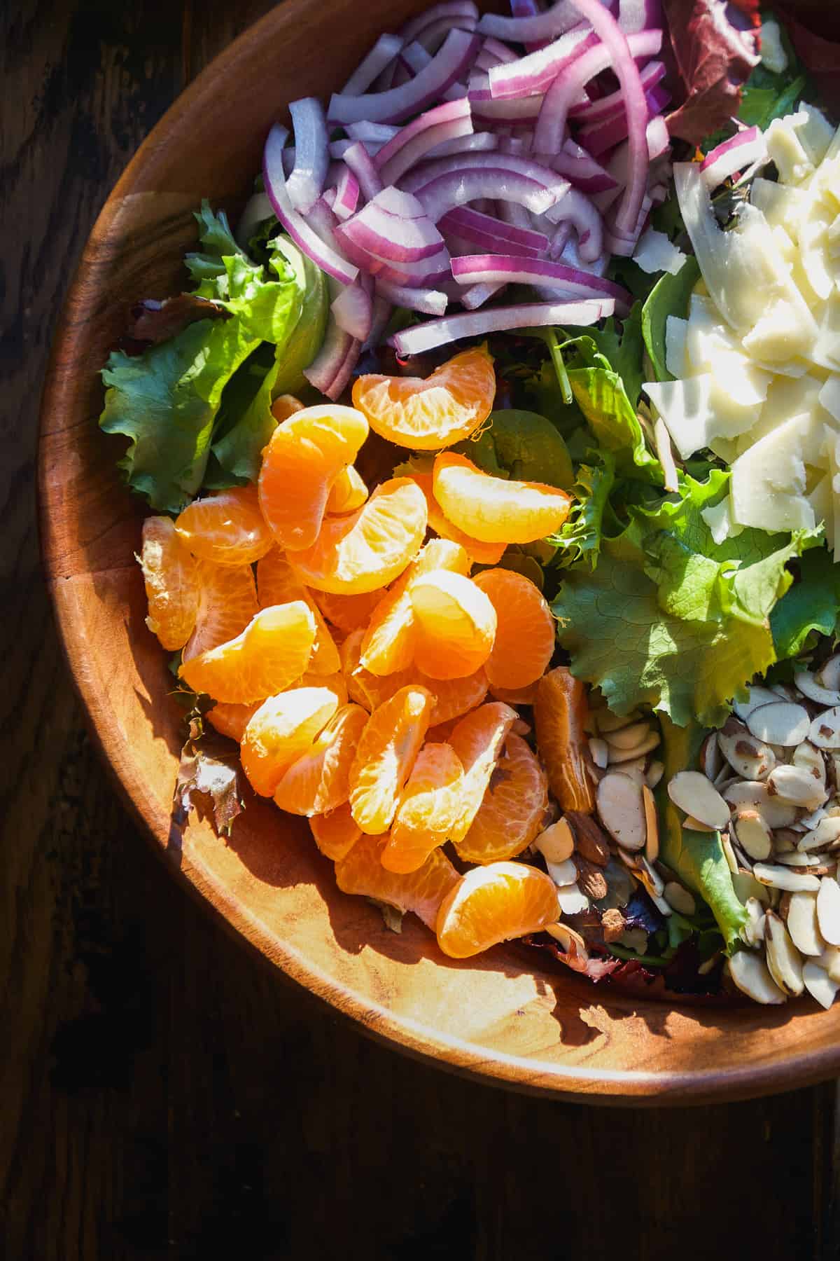 Overhead view of mandarin orange salad ingredients in a bowl.