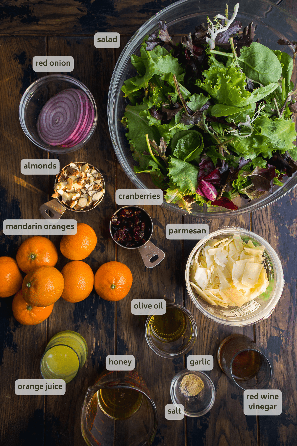 Mandarin orange salad ingredients on a wooden surface.