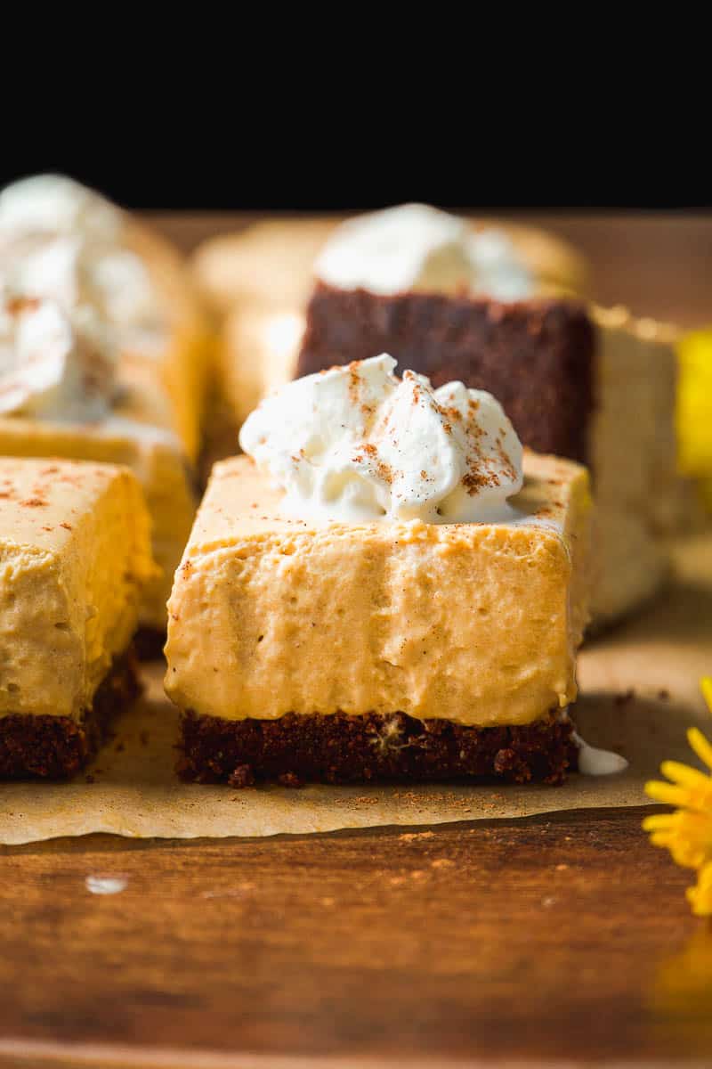 No bake pumpkin cheesecake bar with whipped cream.