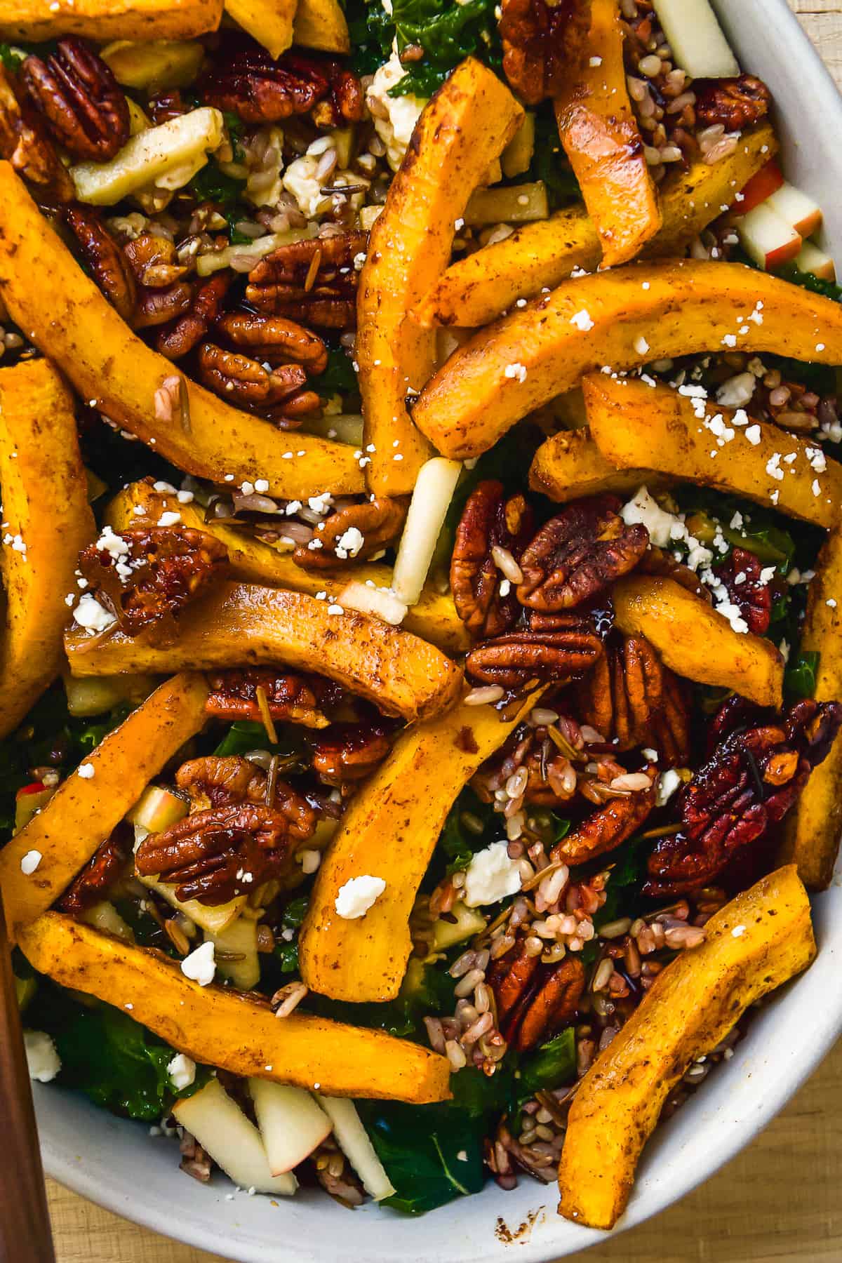 Up close view of a pumpkin salad in a serving dish.