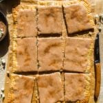 Overhead view of a giant snickerdoodle pop tart cut into pieces.