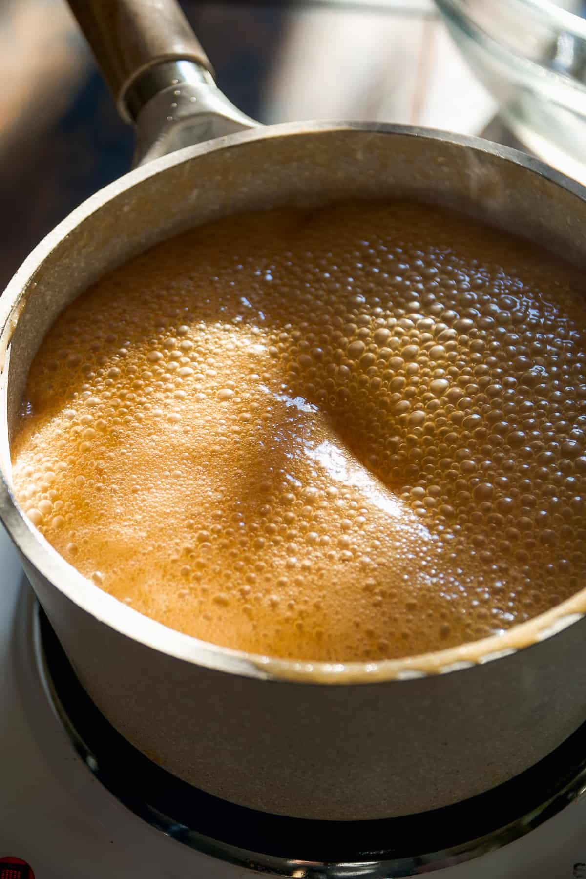 Maple caramel simmering in a pot.