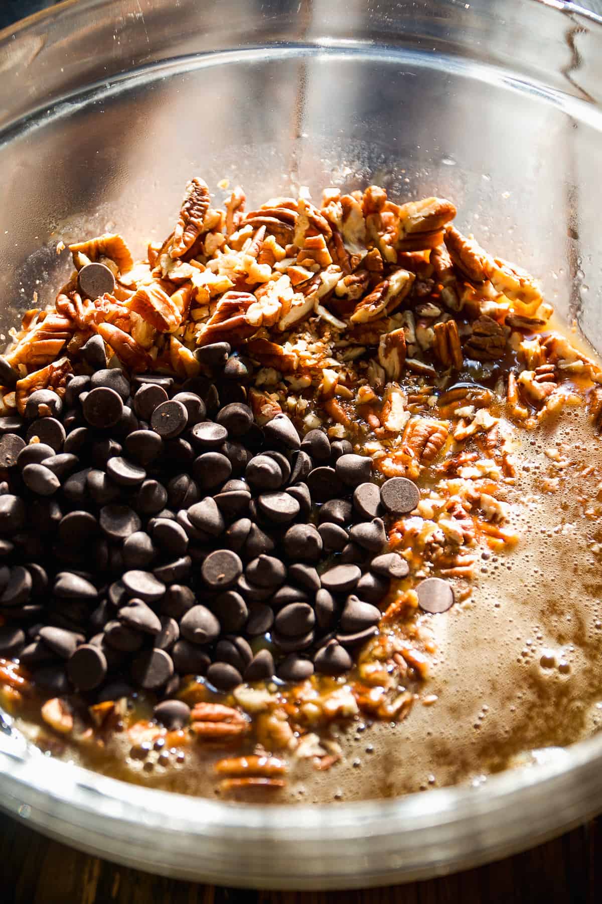 Turtle pie filling about to be mixed in a bowl.