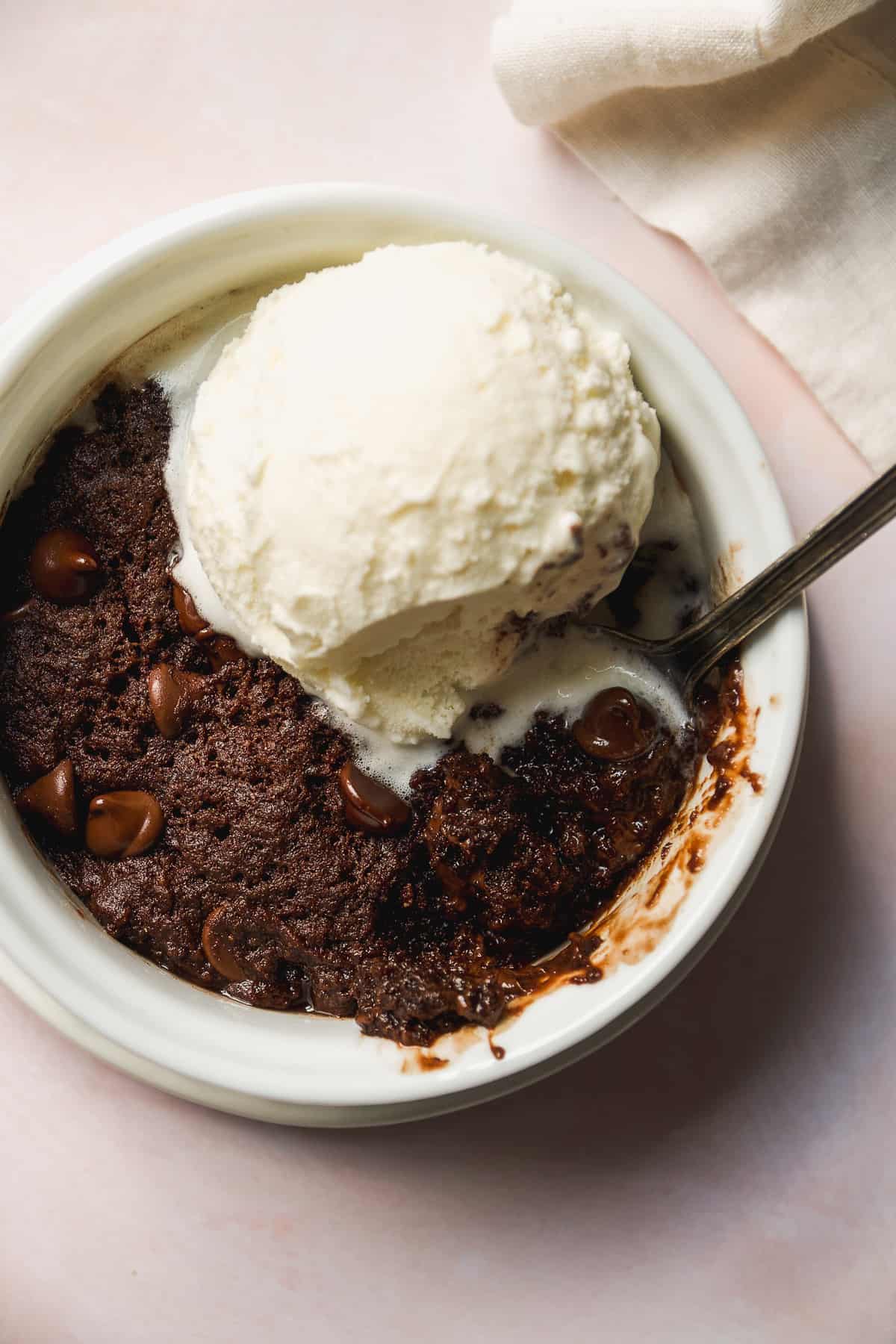 Overhead view of a vegan mug brownie with ice cream.