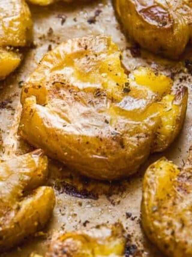 Smashed fingerling potatoes on parchment paper