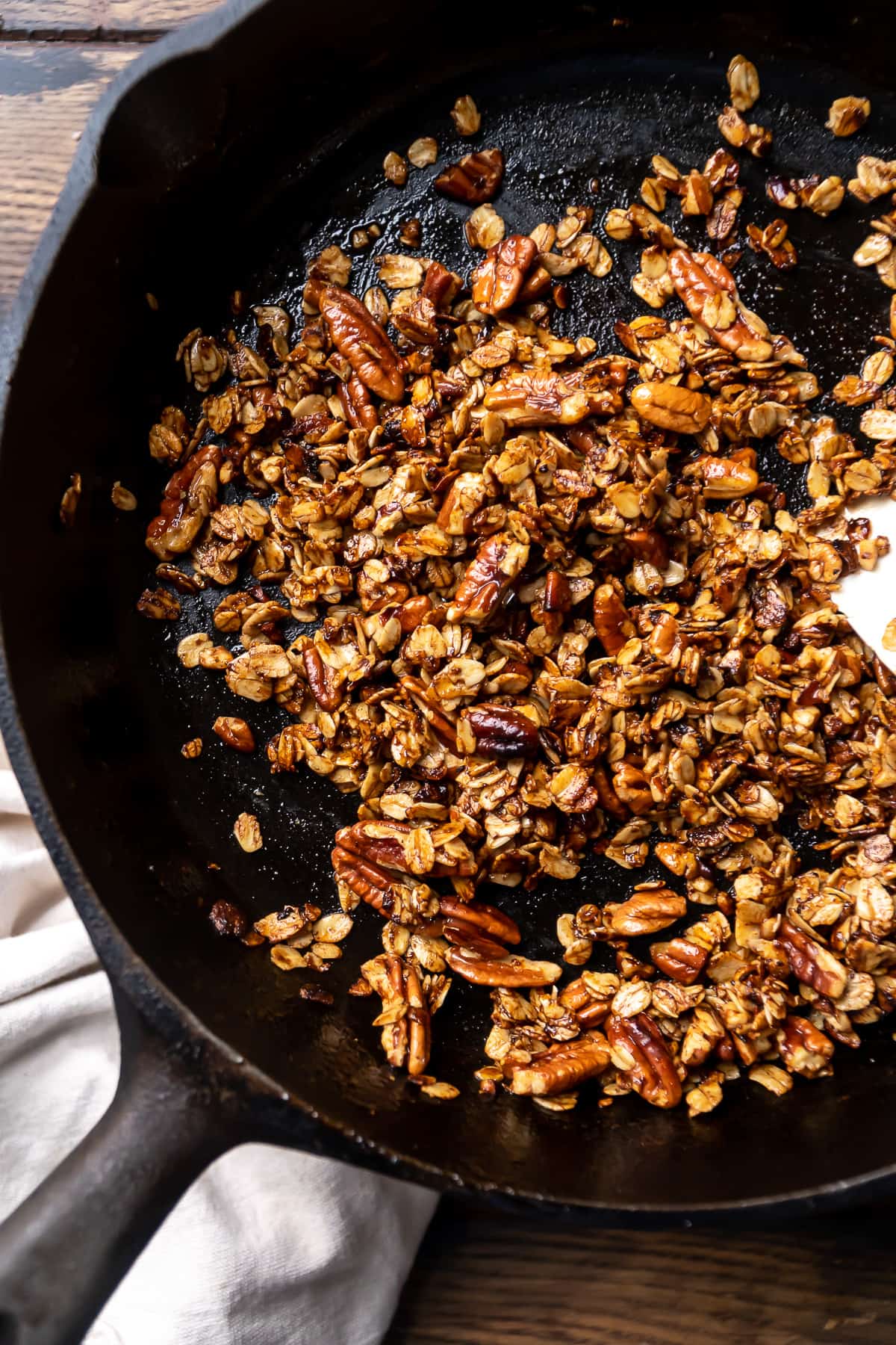 Oats cooking in a black cast iron pan.