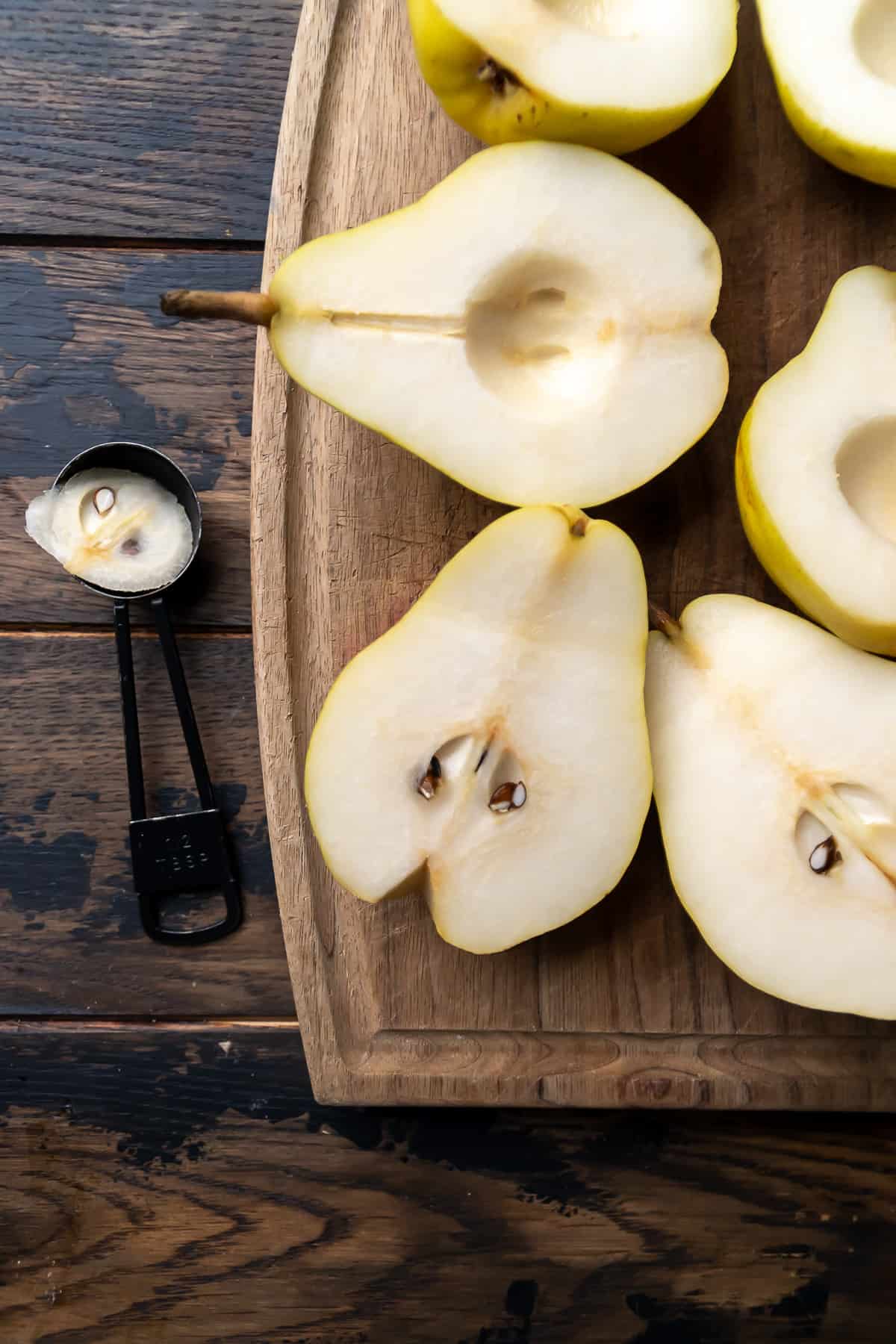Pear halves cut on a wooden surface.