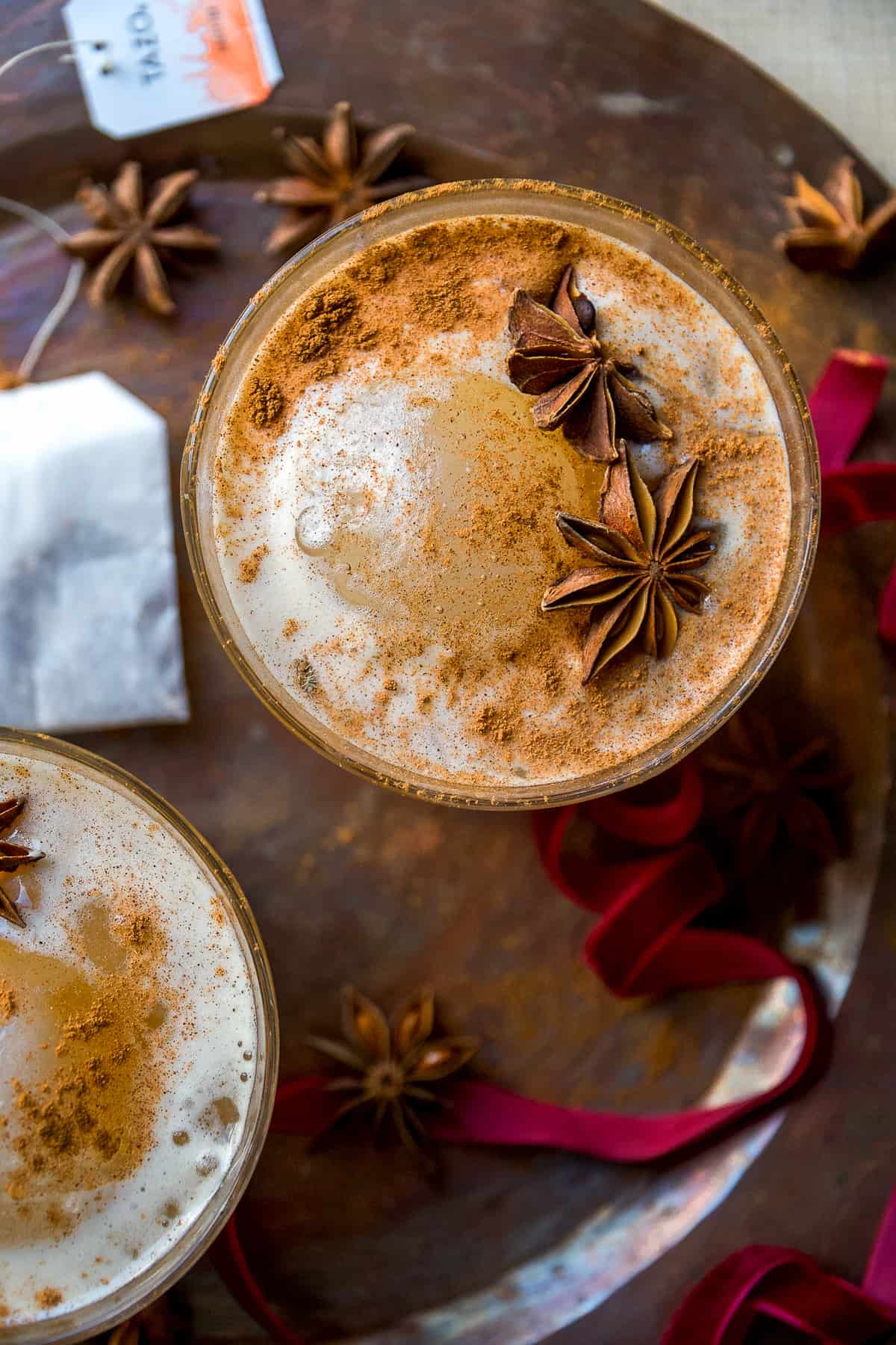 Chai cocktails in a glass with star anise on top.