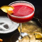 Christmas margarita on a gold platter with salt.