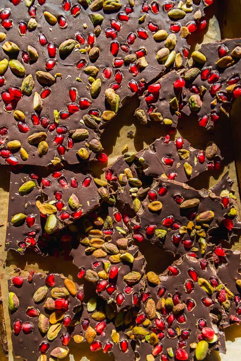 Chocolate Christmas bark with pomegranates and pistachios sprinkled on top.