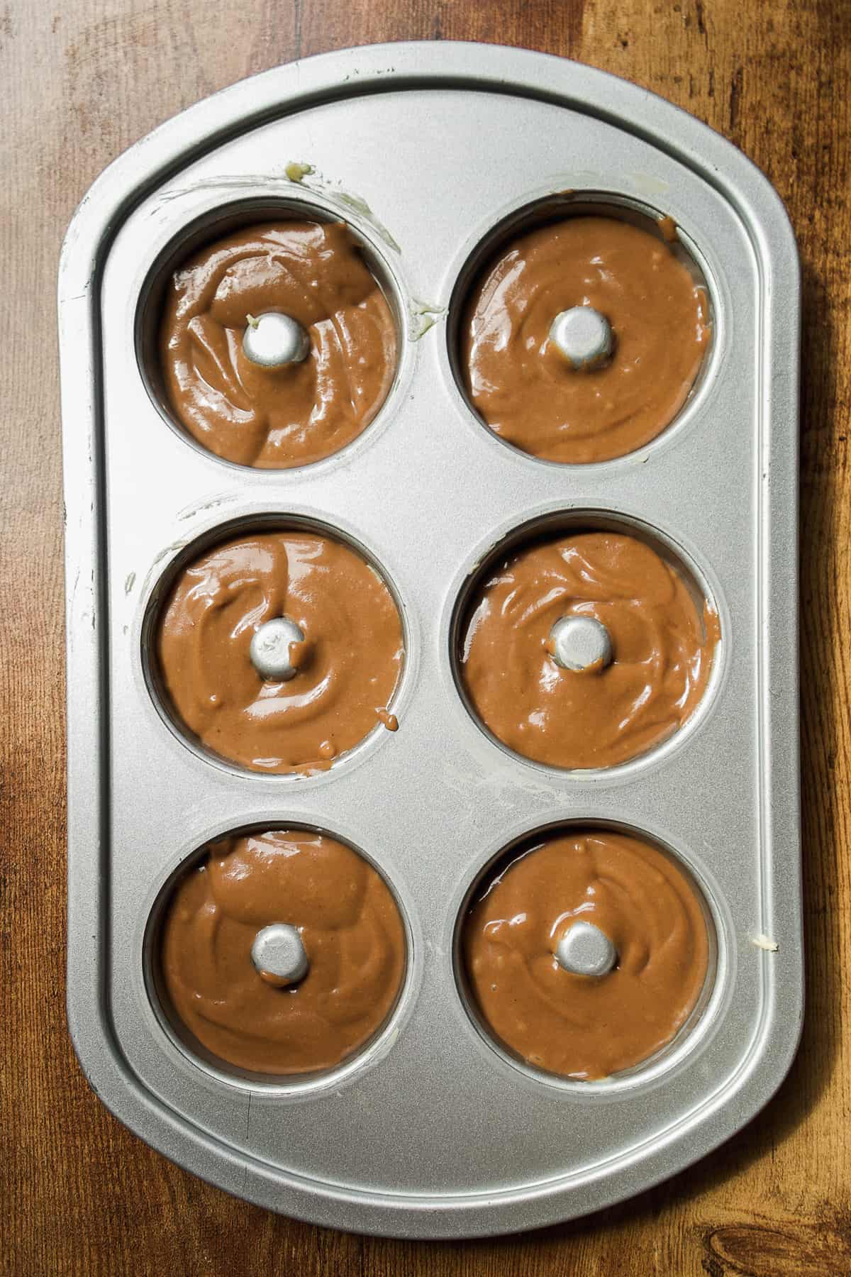 Coffee doughnuts about to be baked in the oven.