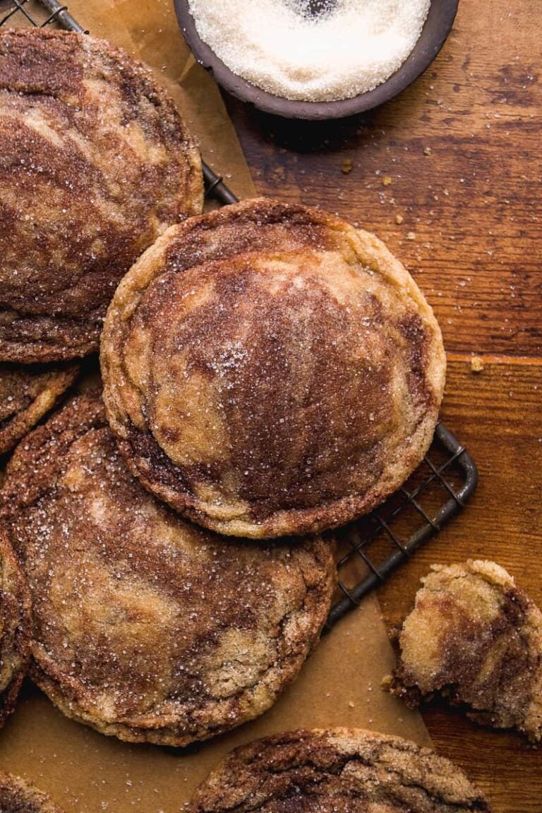 Marbled cookies scattered on a cookie sheet with sugar.