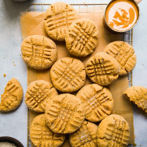 Peanut butter almond flour cookies spread out on a wire rack.