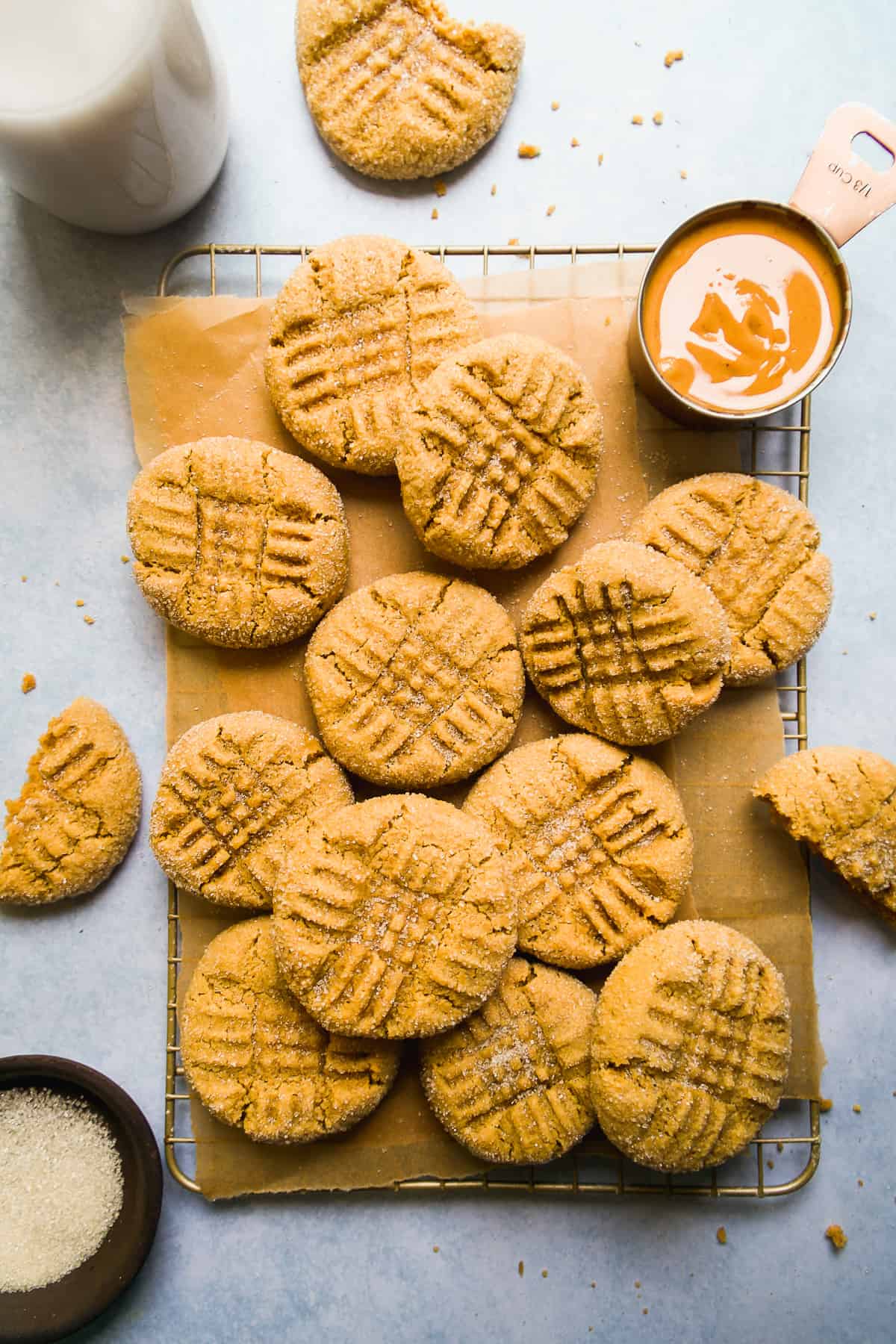 Peanut butter almond flour cookies spread out on a wire rack.