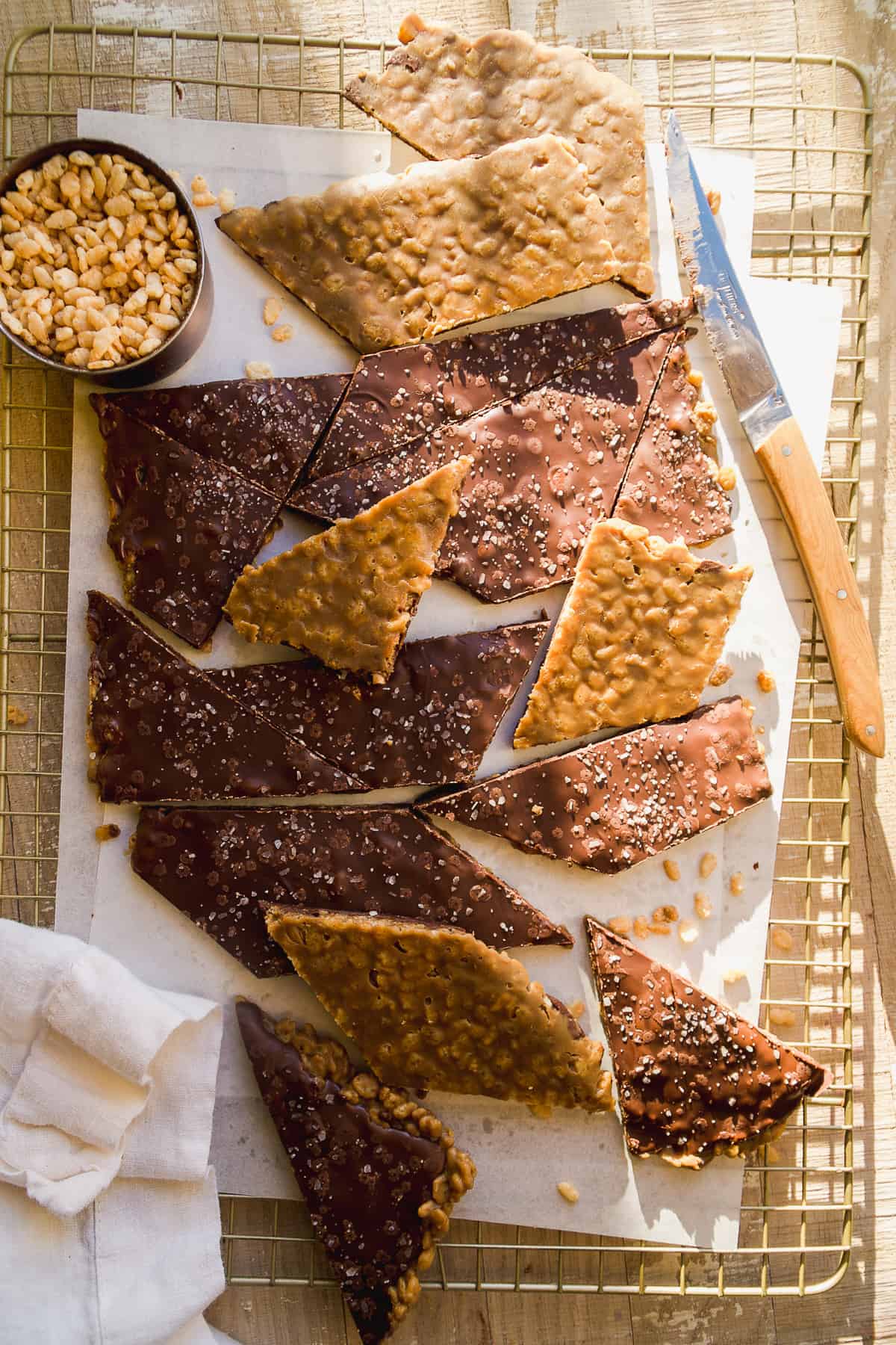 Scotcharoo bars cut into pieces on a cooling rack.