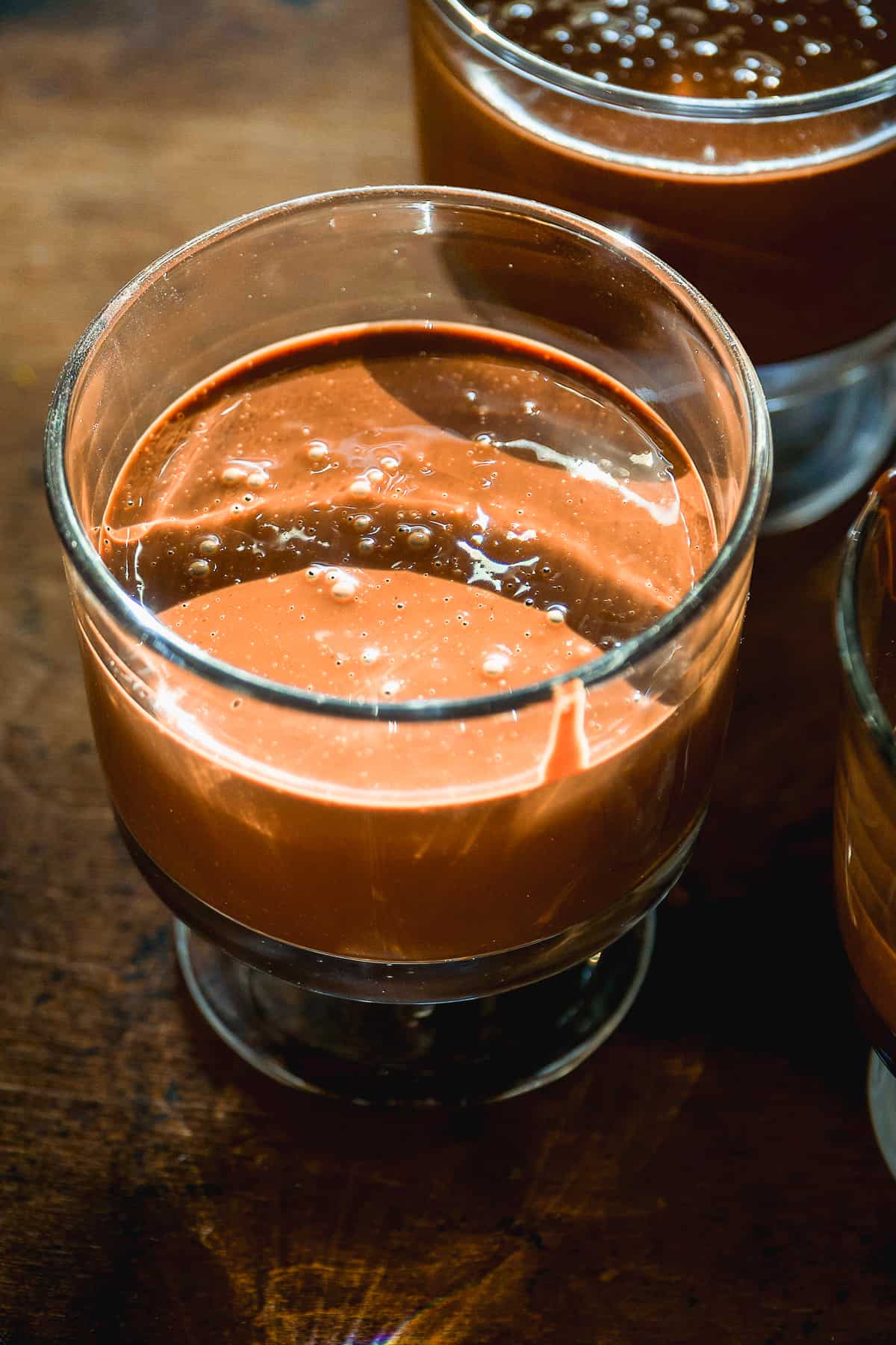 Chocolate mousse poured in a glass jar about to be chilled.