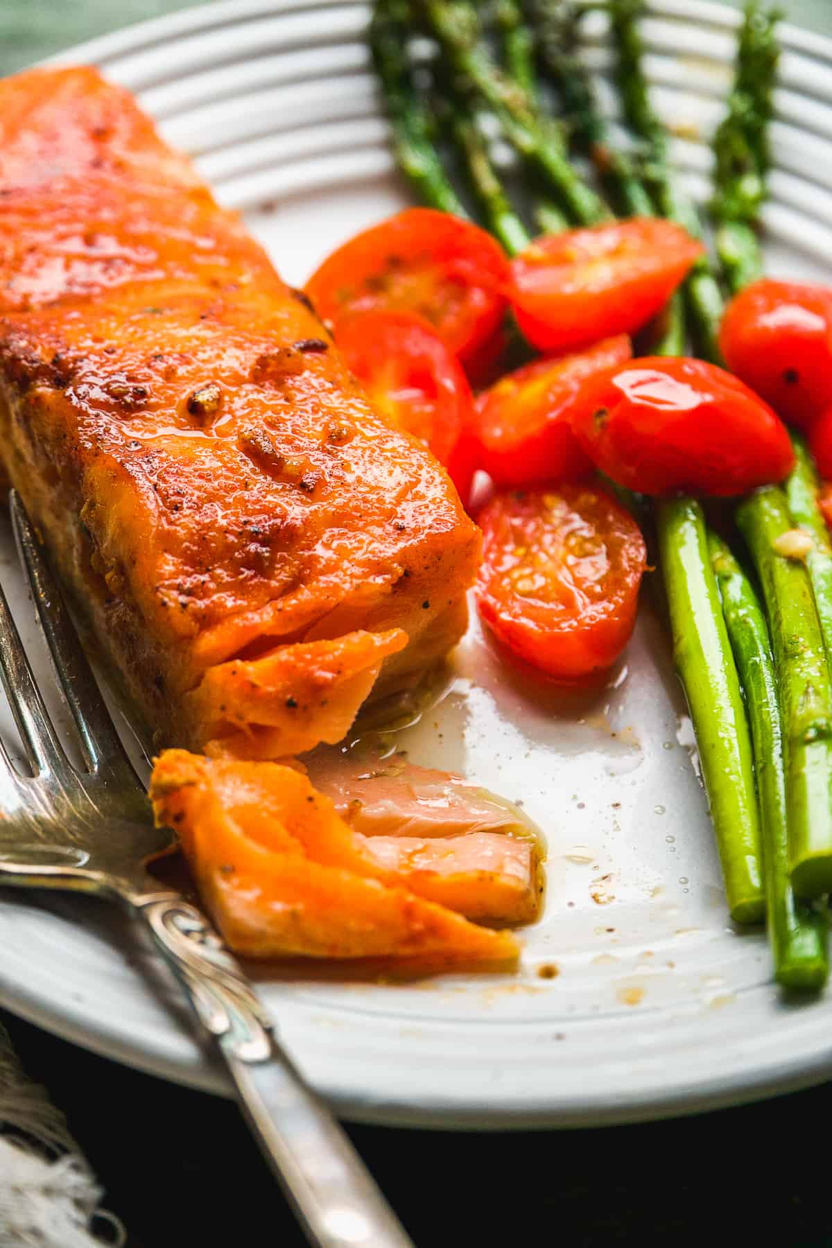 Salmon filet on a plate with a fork.