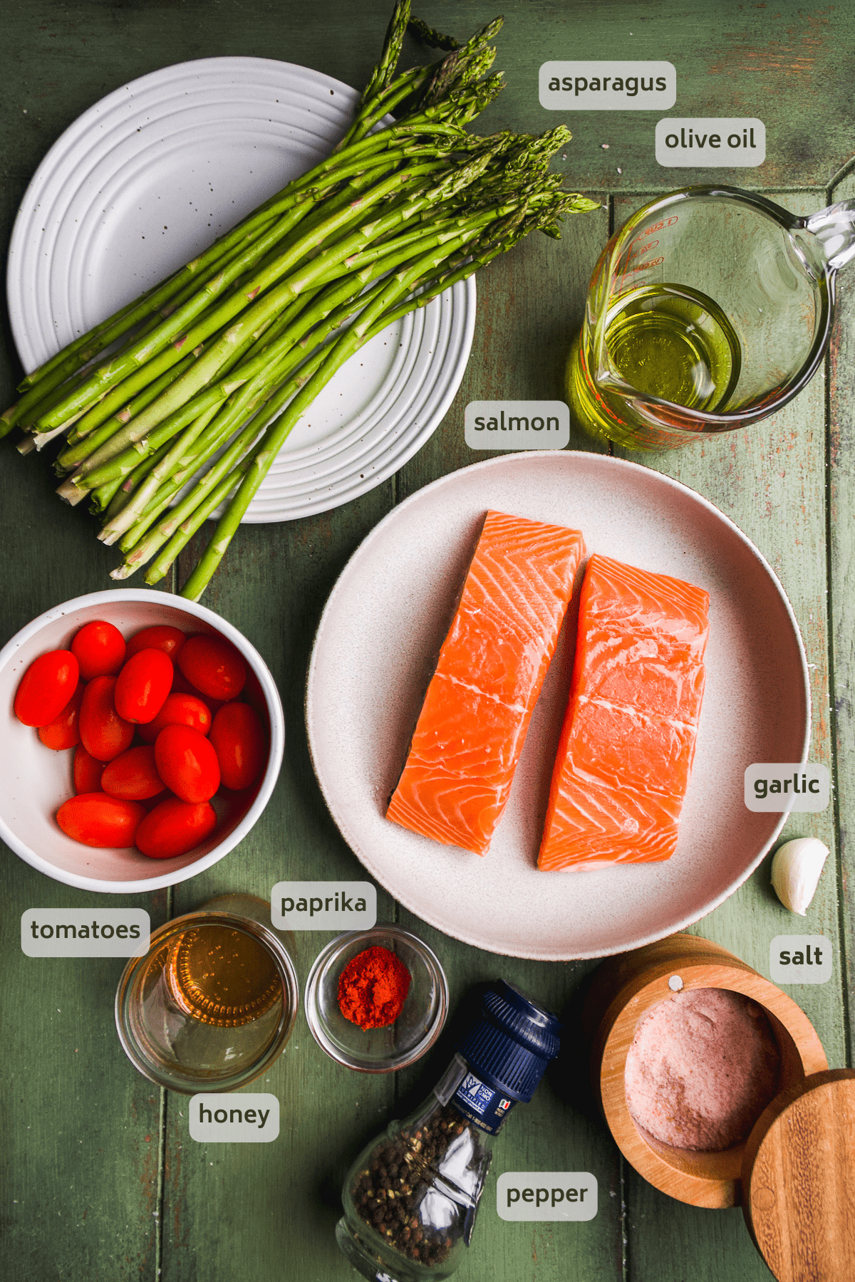 Cast iron salmon ingredients on a green surface.