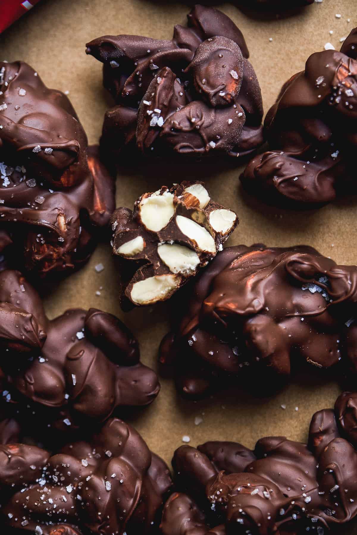 Sea salt almond clusters scattered on a baking sheet.