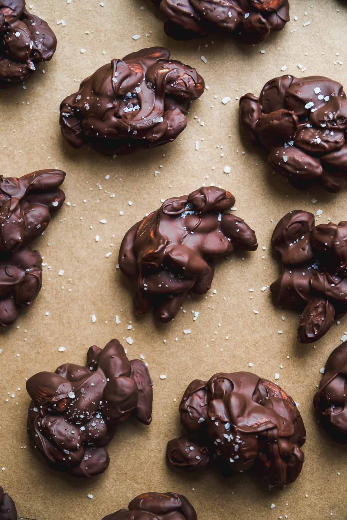 Chocolate almond clusters on a baking sheet.