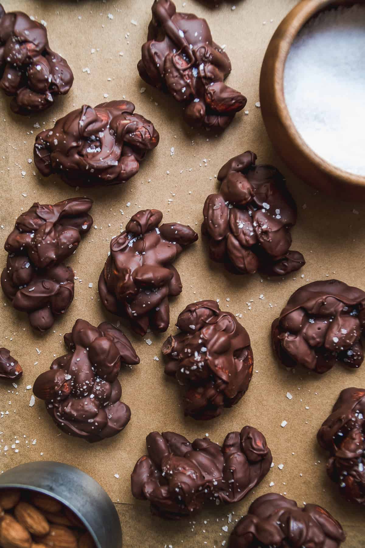 Almond clusters with chocolate on a baking sheet.