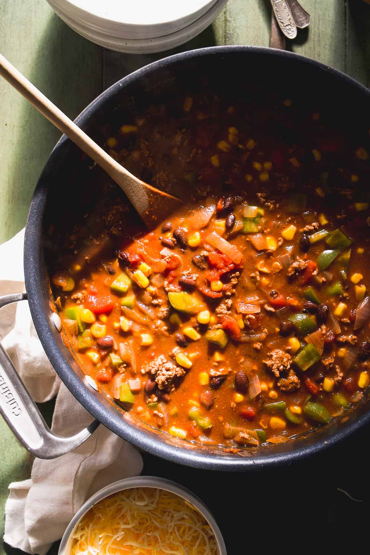 Large pot of sweet chili with a spoon and bowls to the side.