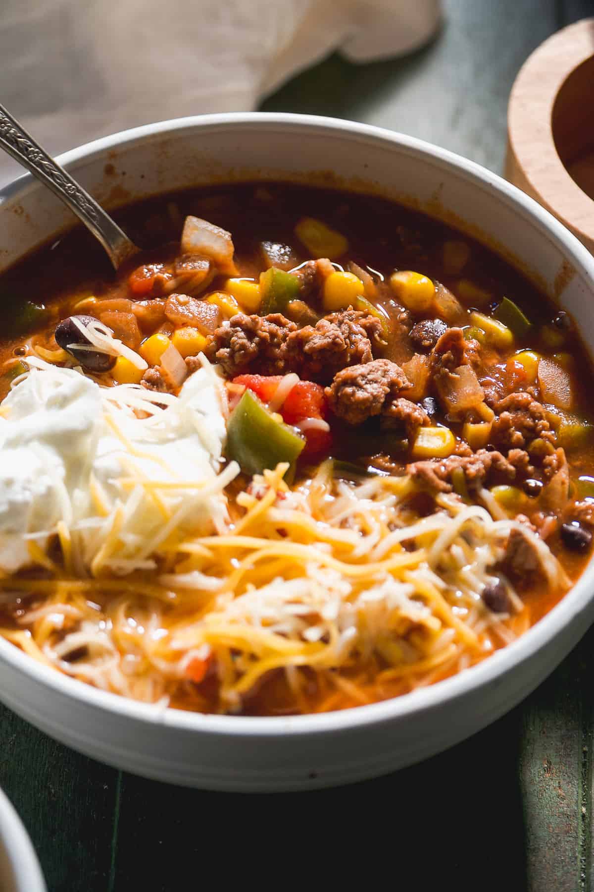 Chili in a bowl with cheese and yogurt.