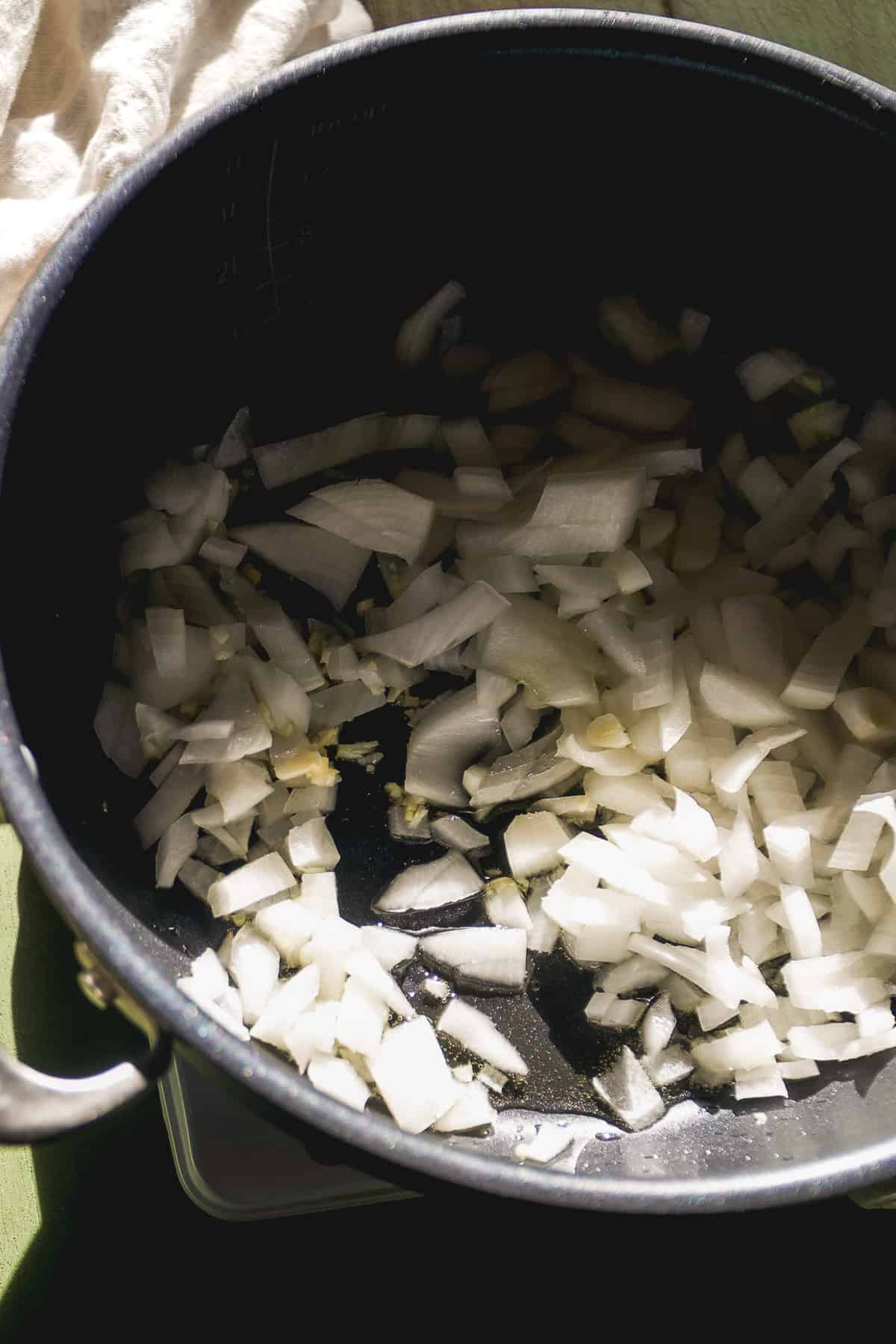 White onion cooking in a large pot.