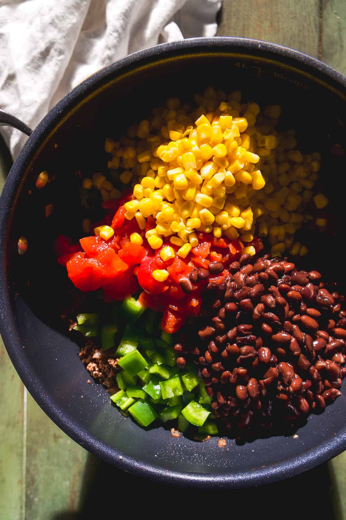 Overhead view of a large pot with produce and vegetables.