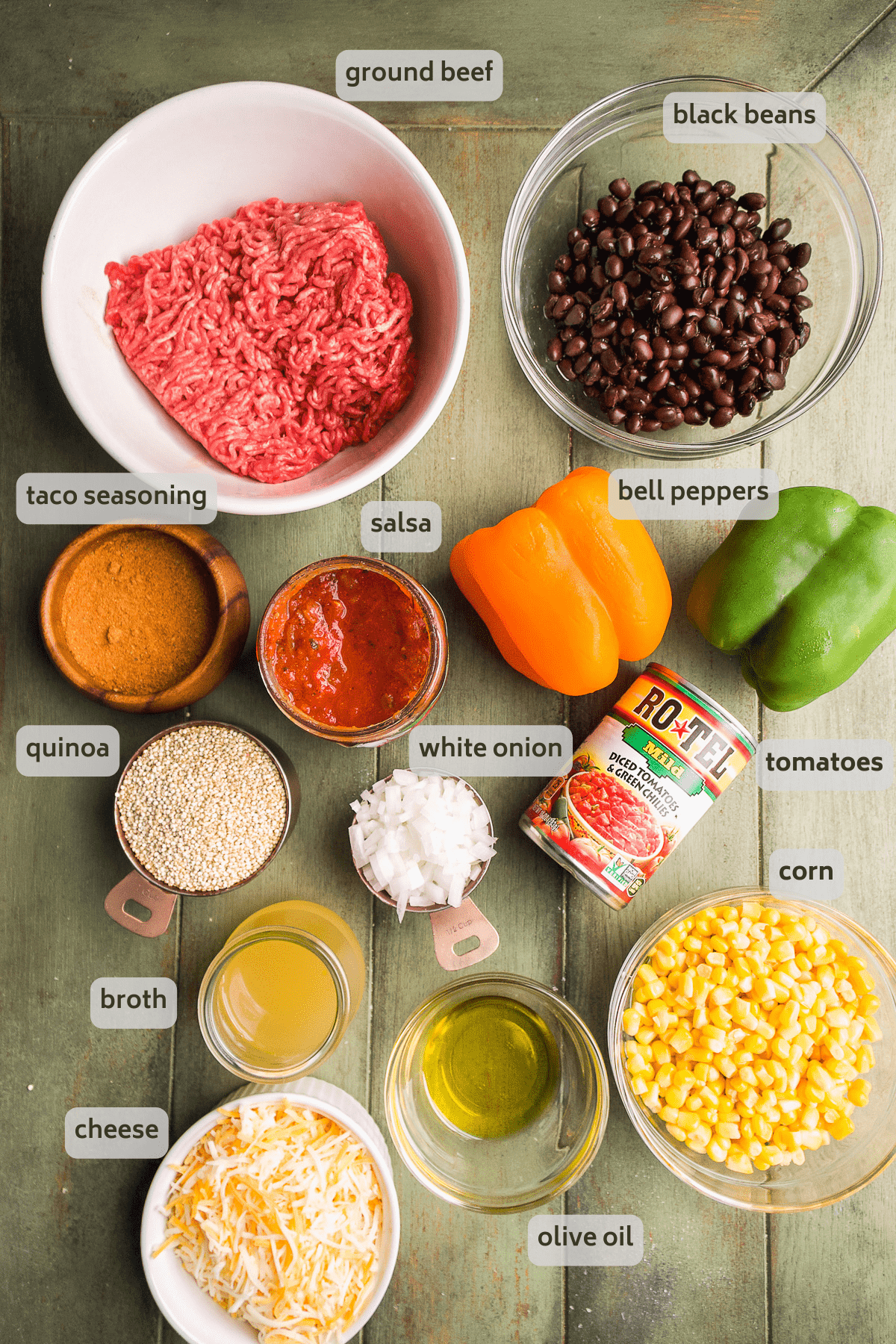 Taco casserole ingredients on a green surface.