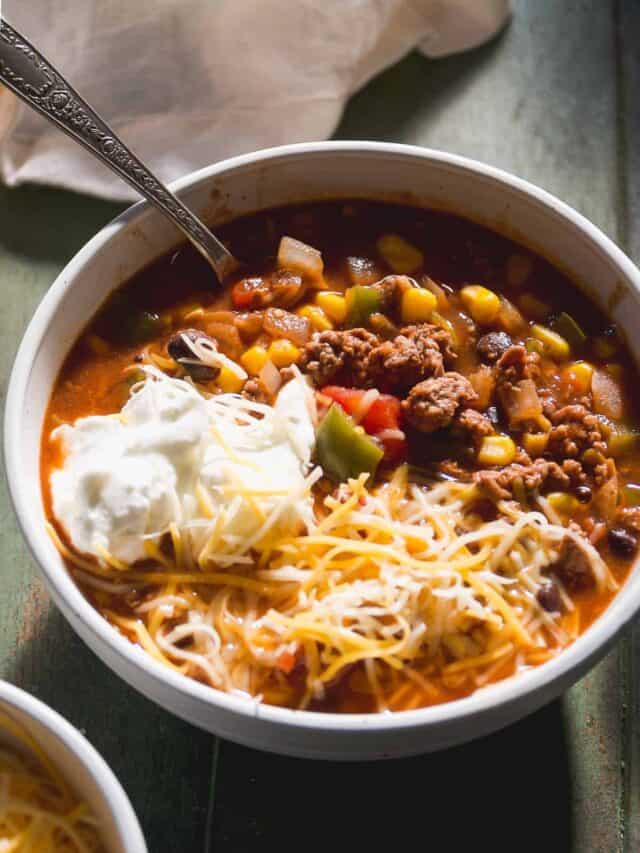 Bowl of sweet chili with cheese and yogurt on top.