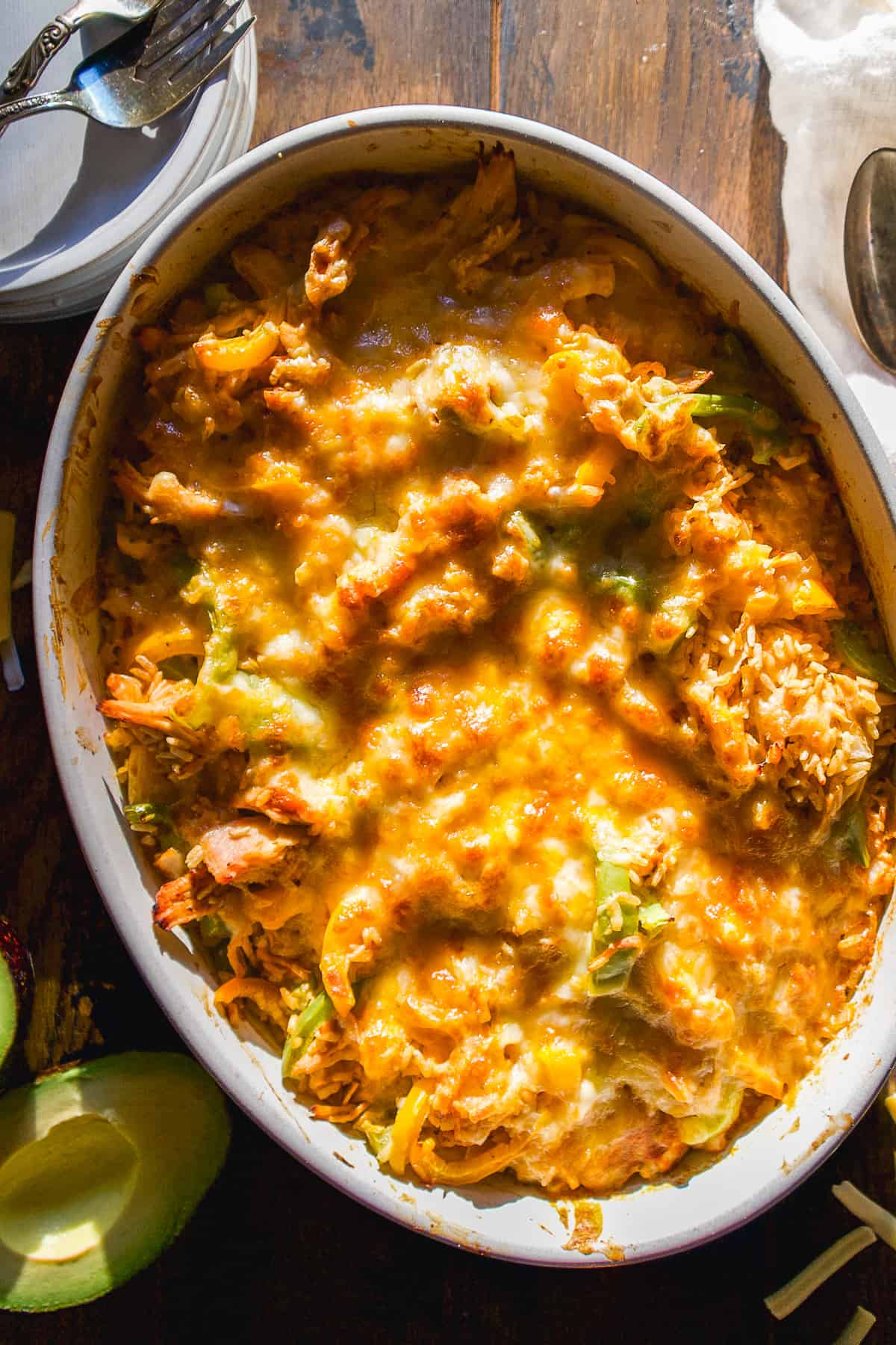 Chicken fajita casserole in an oval dish with plate on the side.