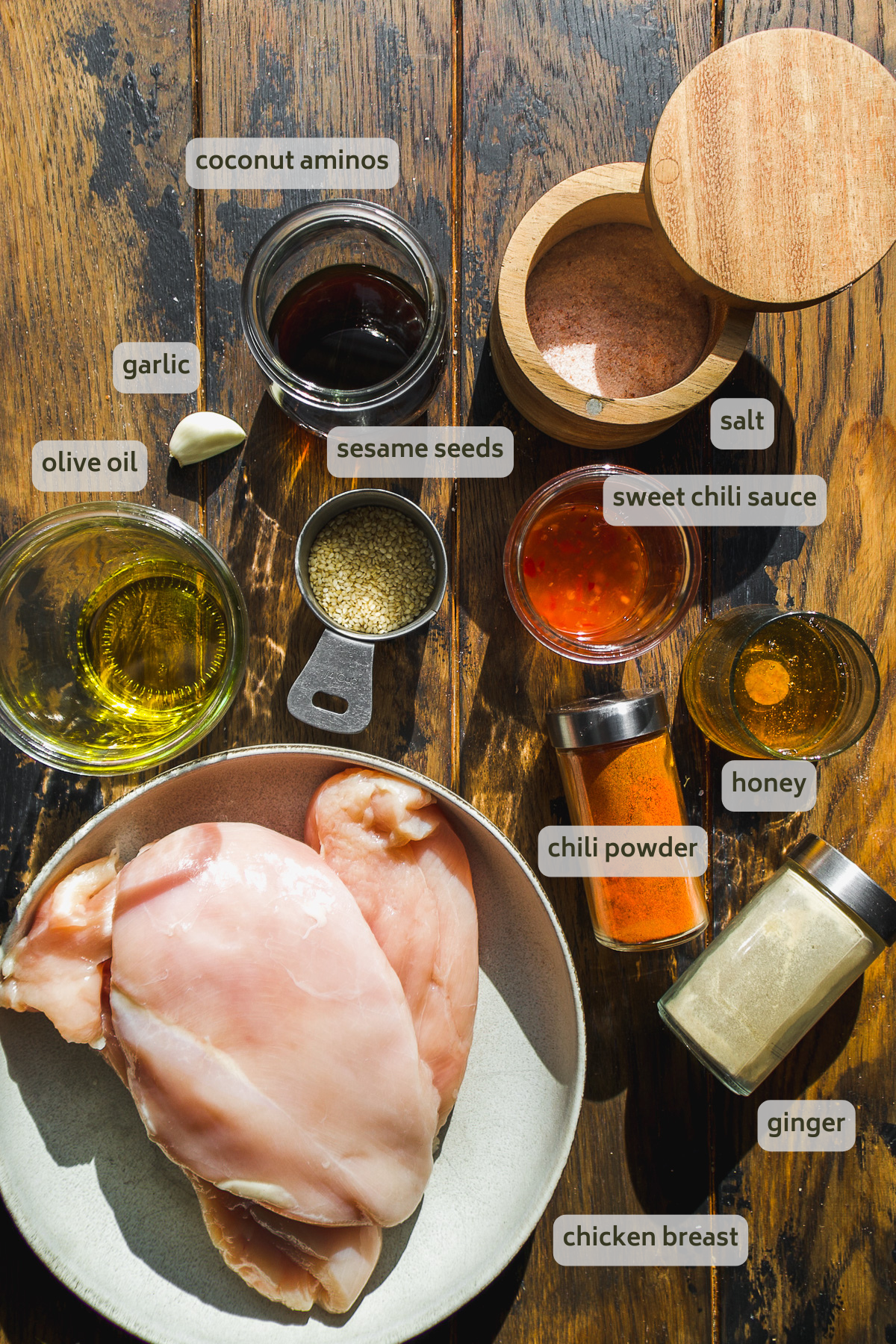 Honey sesame chicken ingredients on a wooden surface.