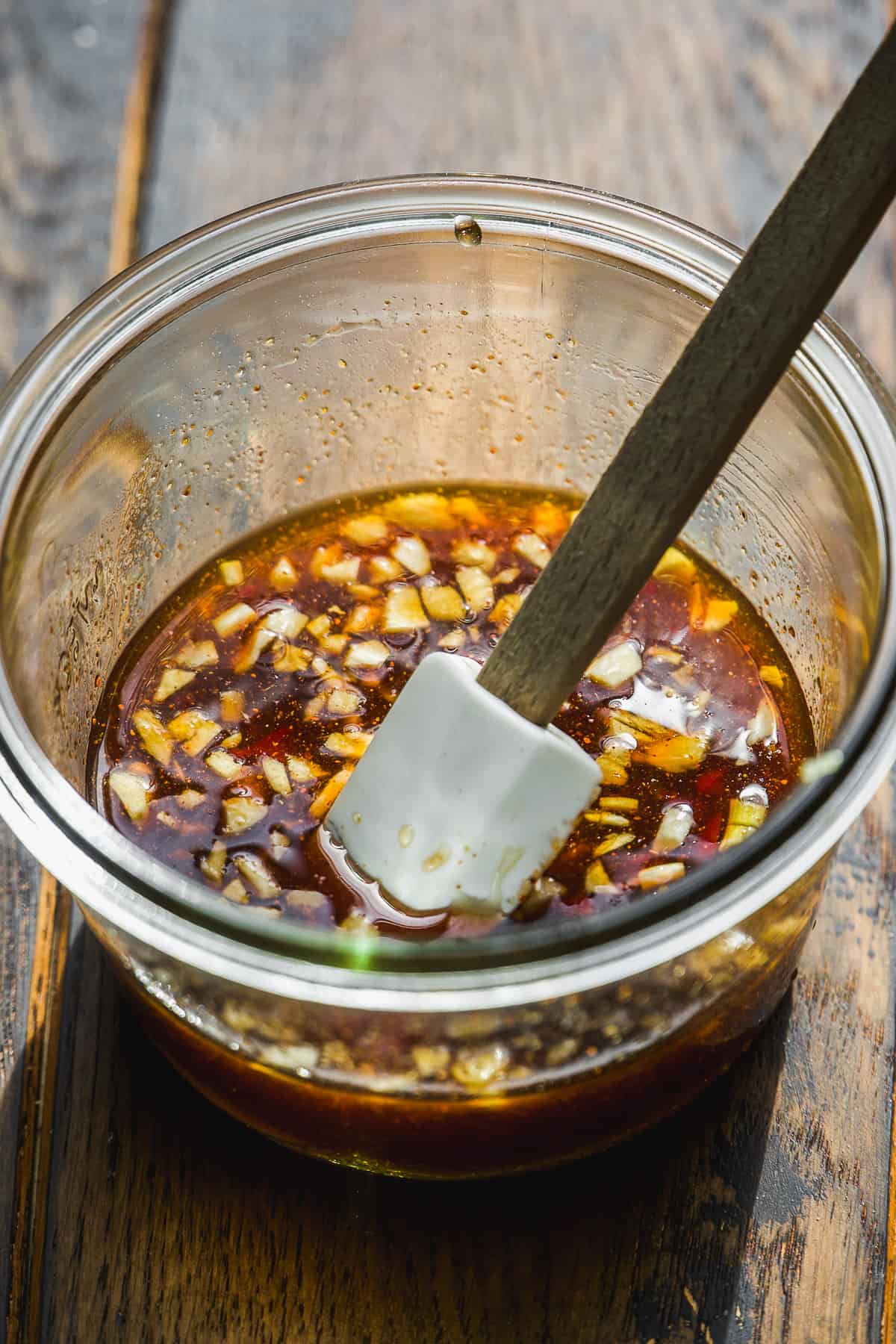 Honey chili sauce in a glass jar.