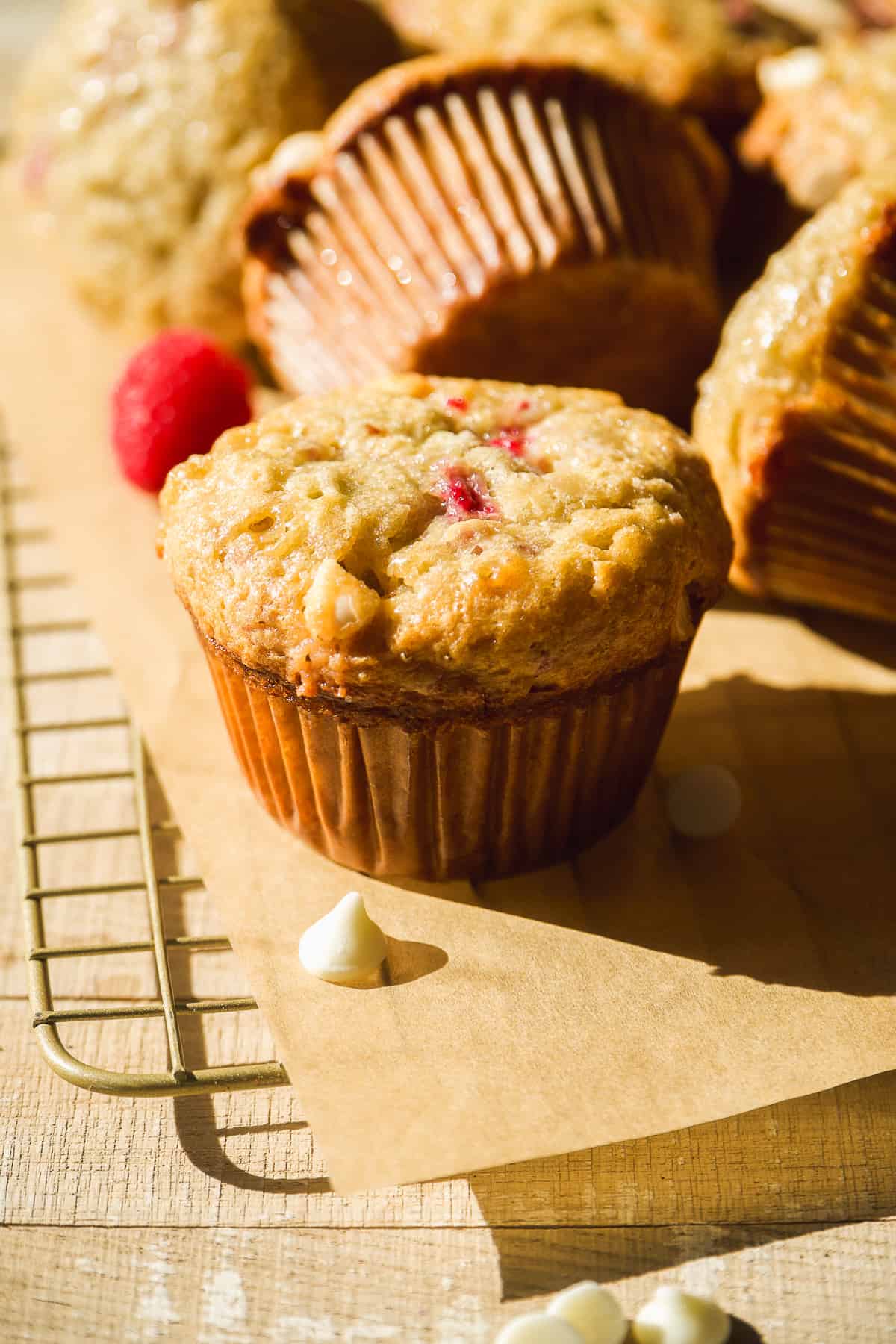 Raspberry white chocolate muffin on a baking sheet.