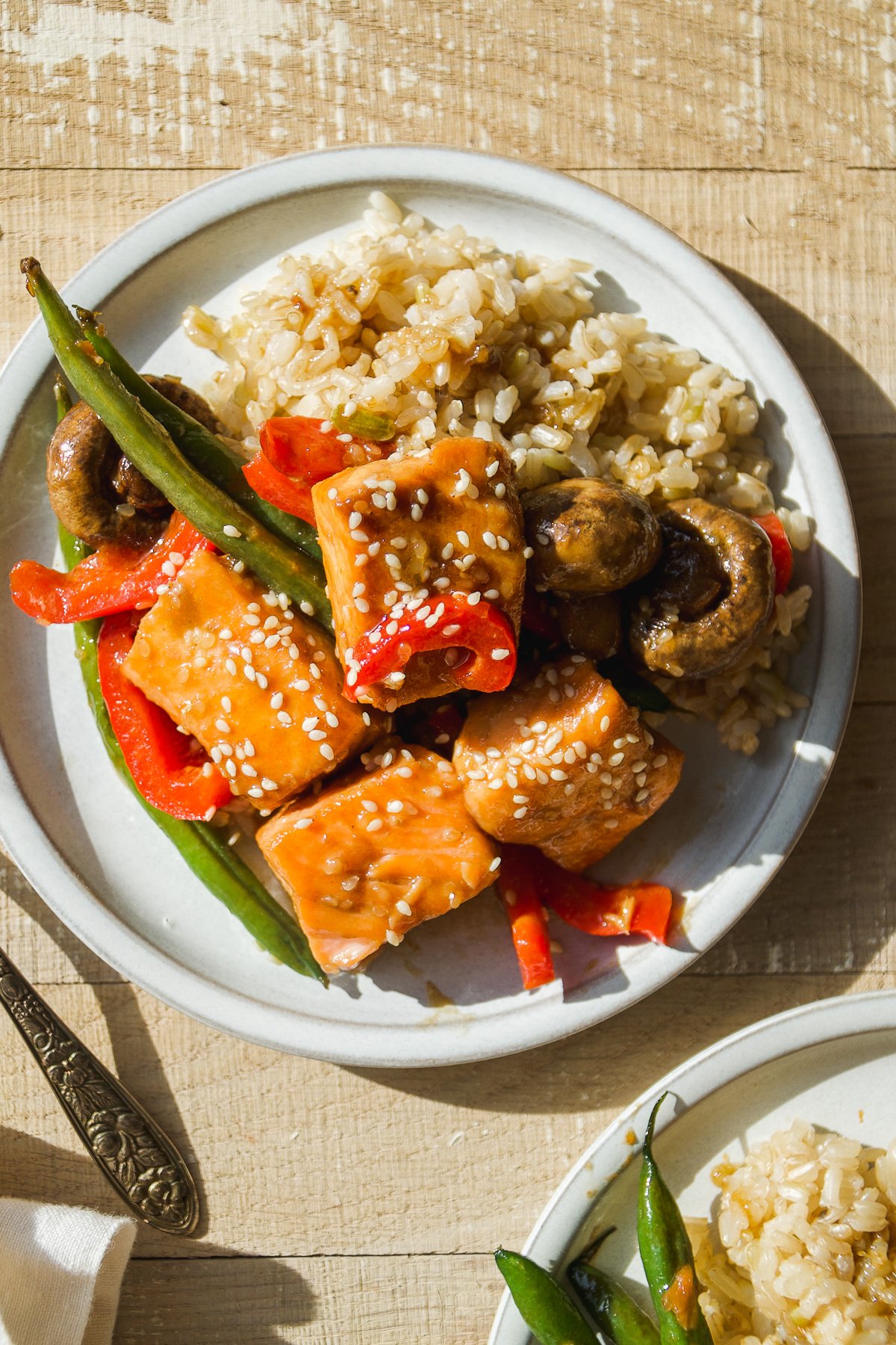 Overhead view of a plate with sesame salmon stir fry.