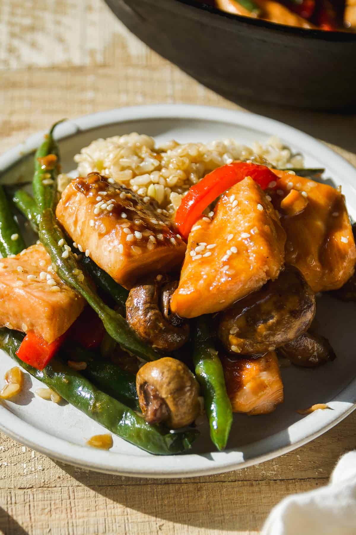 Small plate with salmon stir fry and rice.