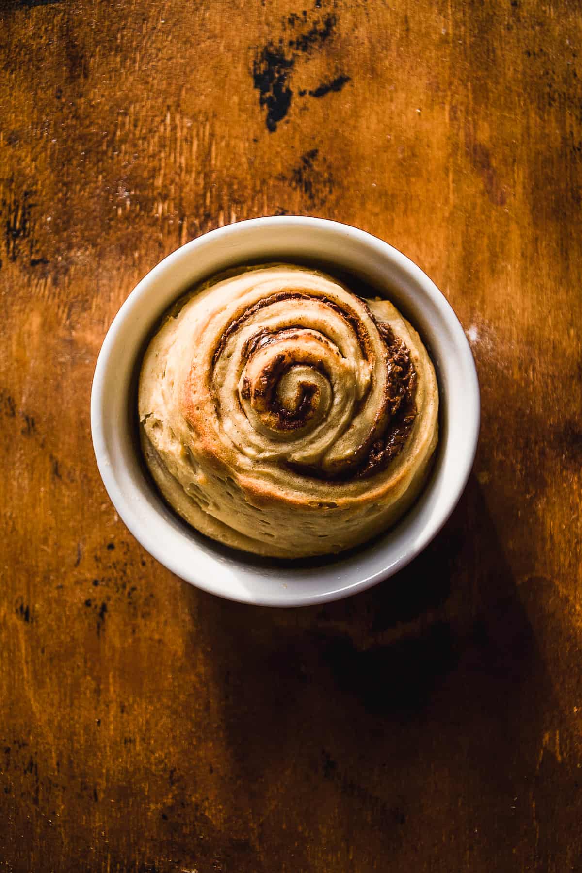 Single serve cinnamon roll baked in a ramekin.